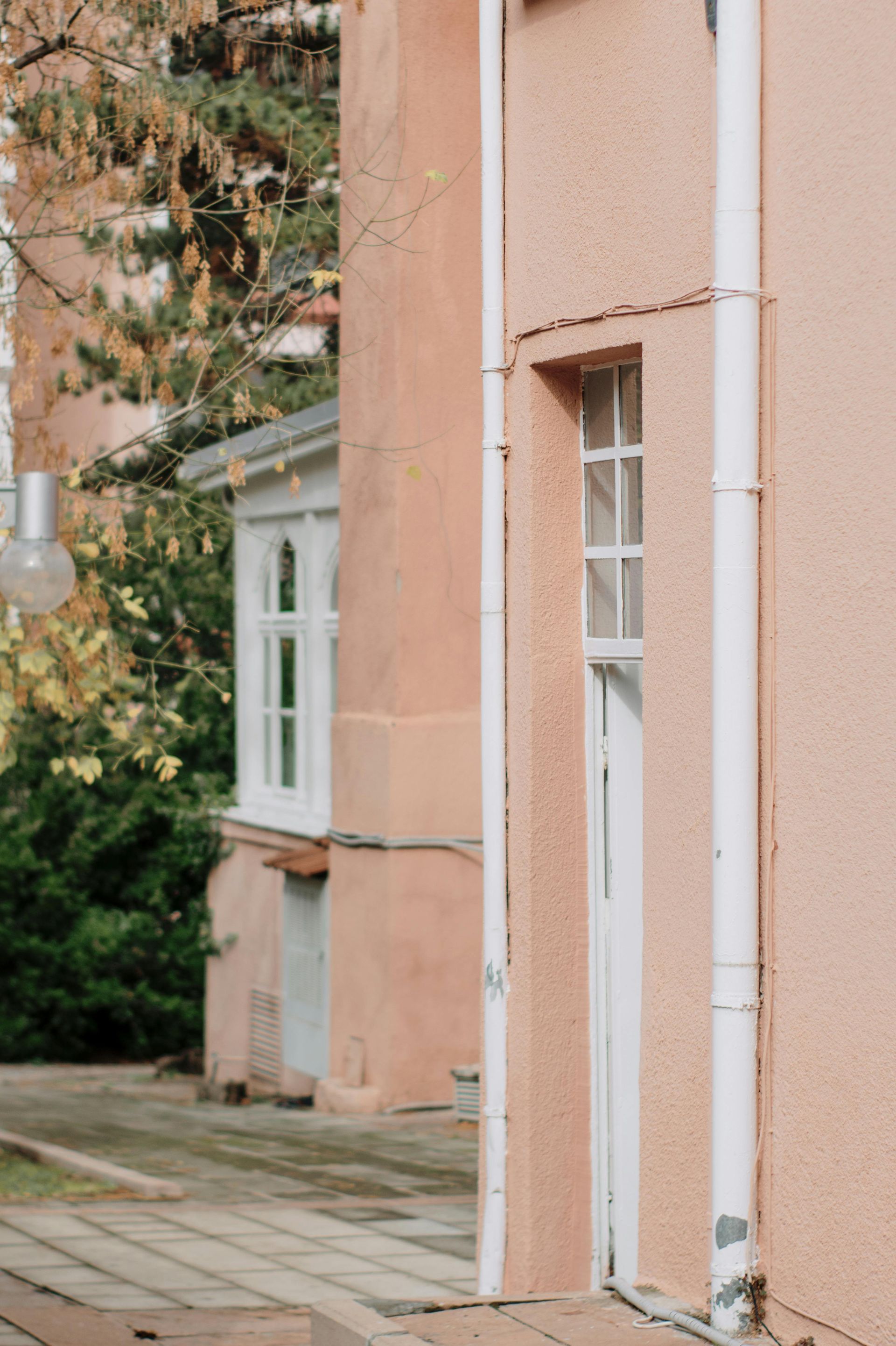 A man is working on an electrical outlet with a screwdriver