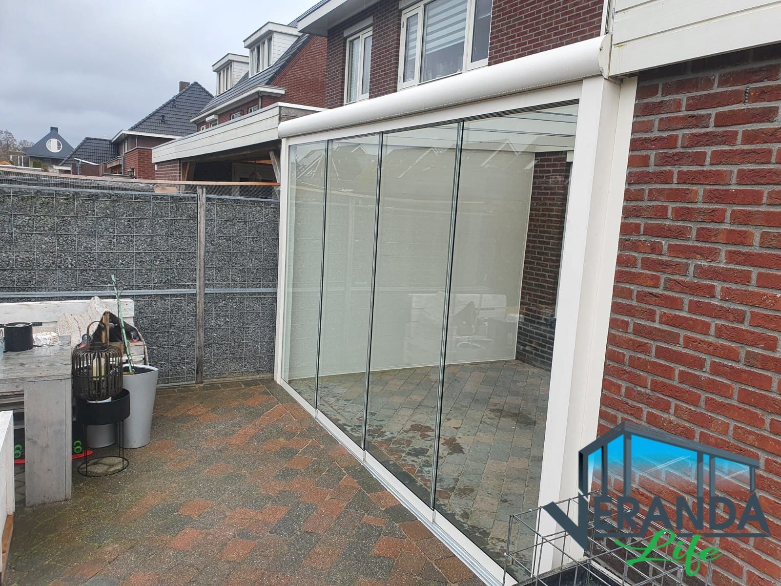 Een bakstenen gebouw met een glazen schuifdeur in de achtertuin.