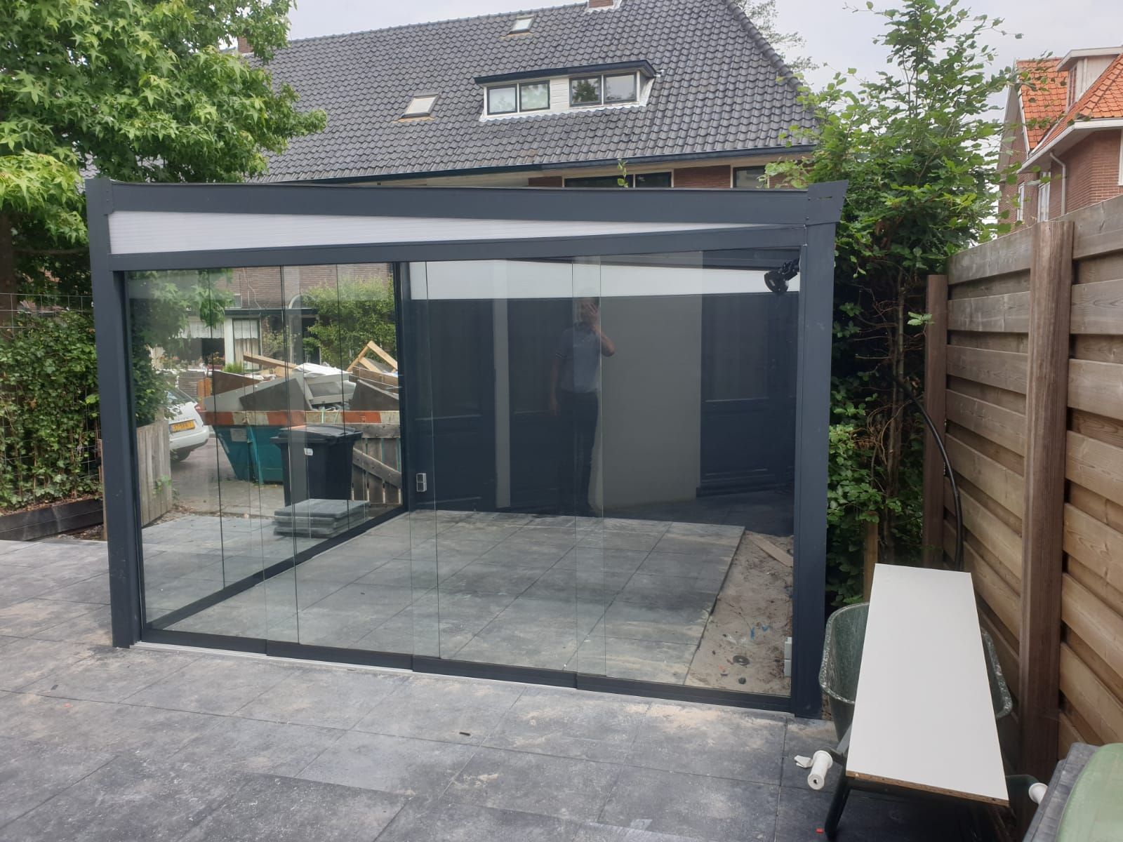Een patio met glazen schuifdeur voor een huis.