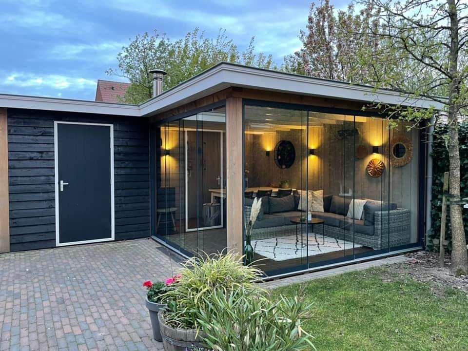 Een klein huis met een woonkamer en een glazen schuifdeur.