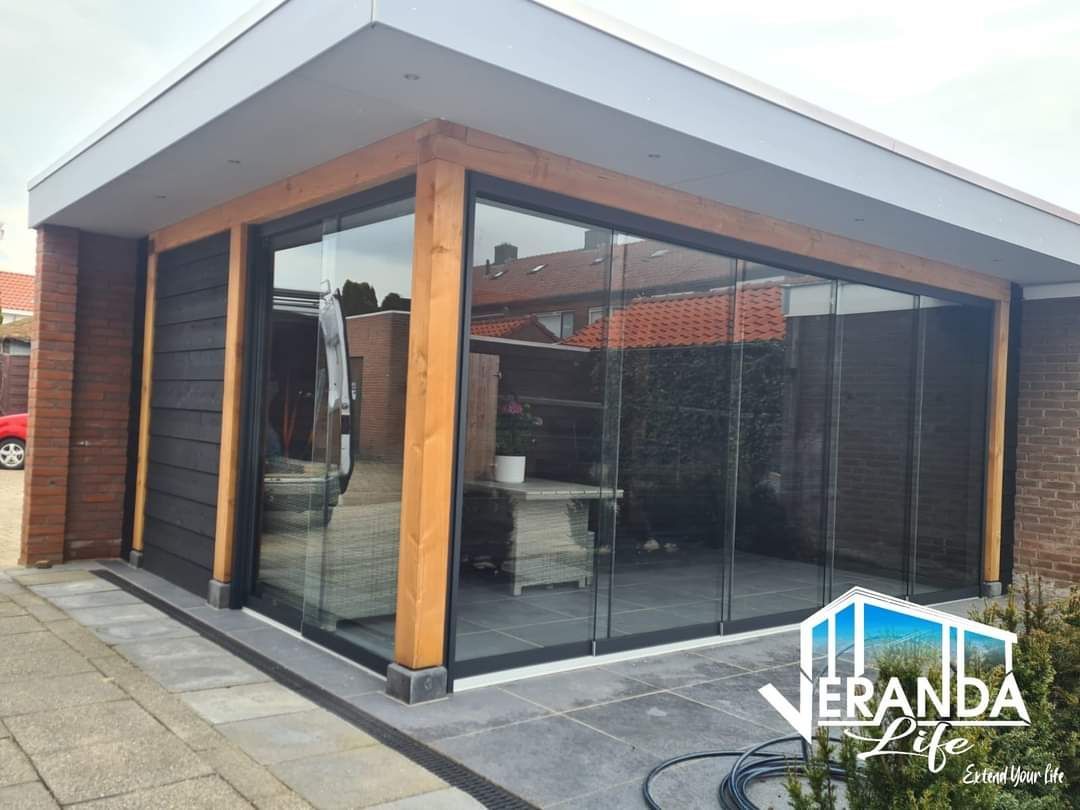 Een huis met glazen schuifdeuren en een houten frame.