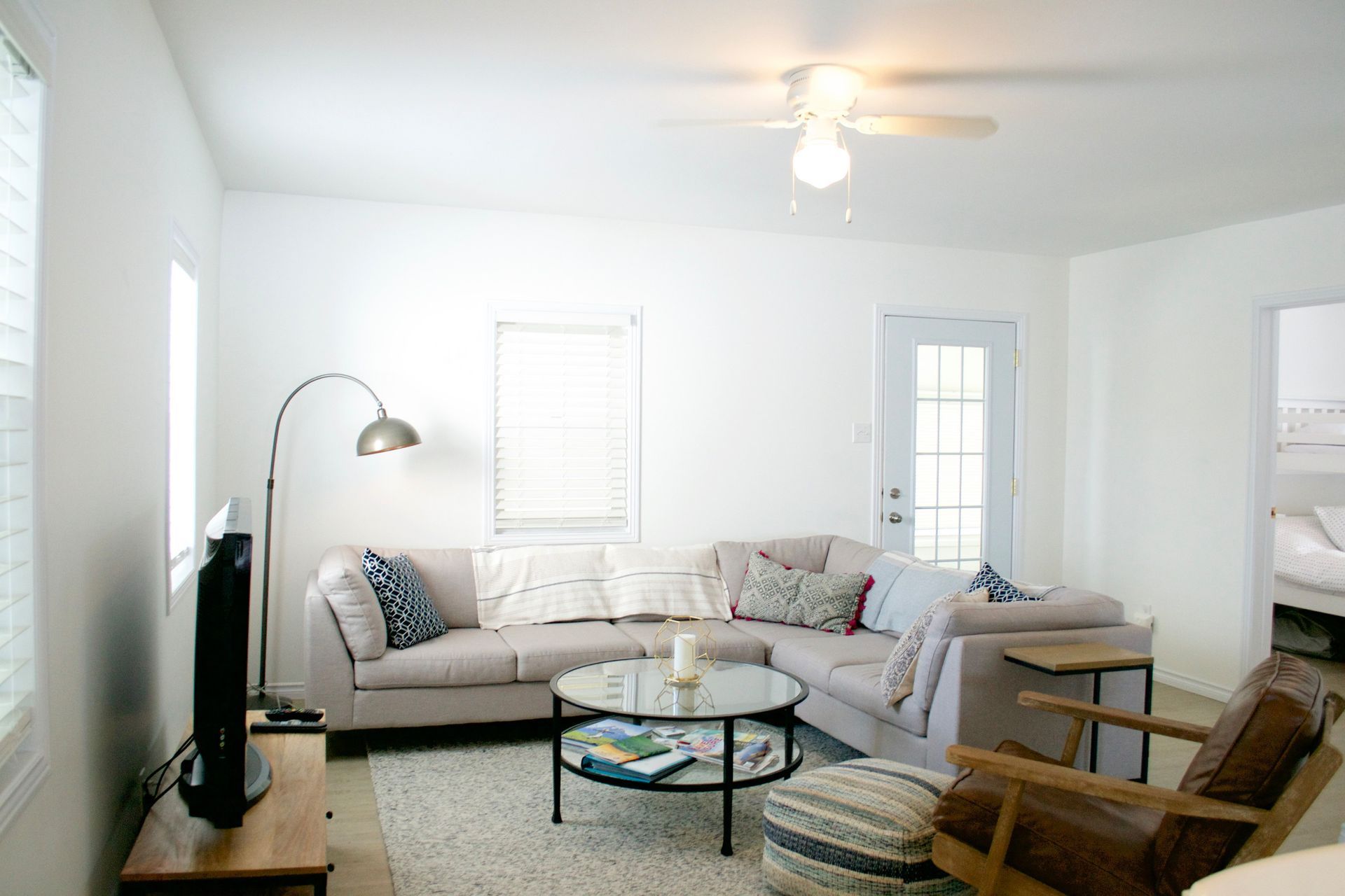 Living room with sectional sofa, coffee table, and chair.