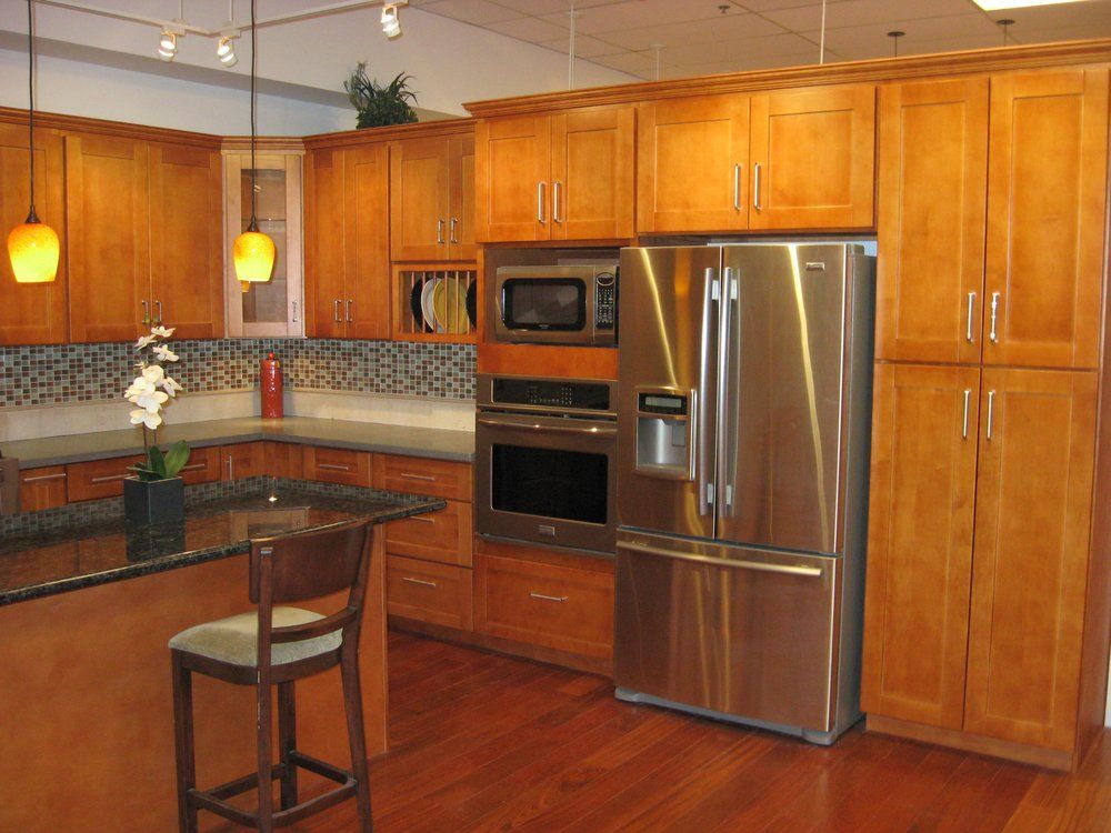 a kitchen with stainless steel appliances and wooden cabinets