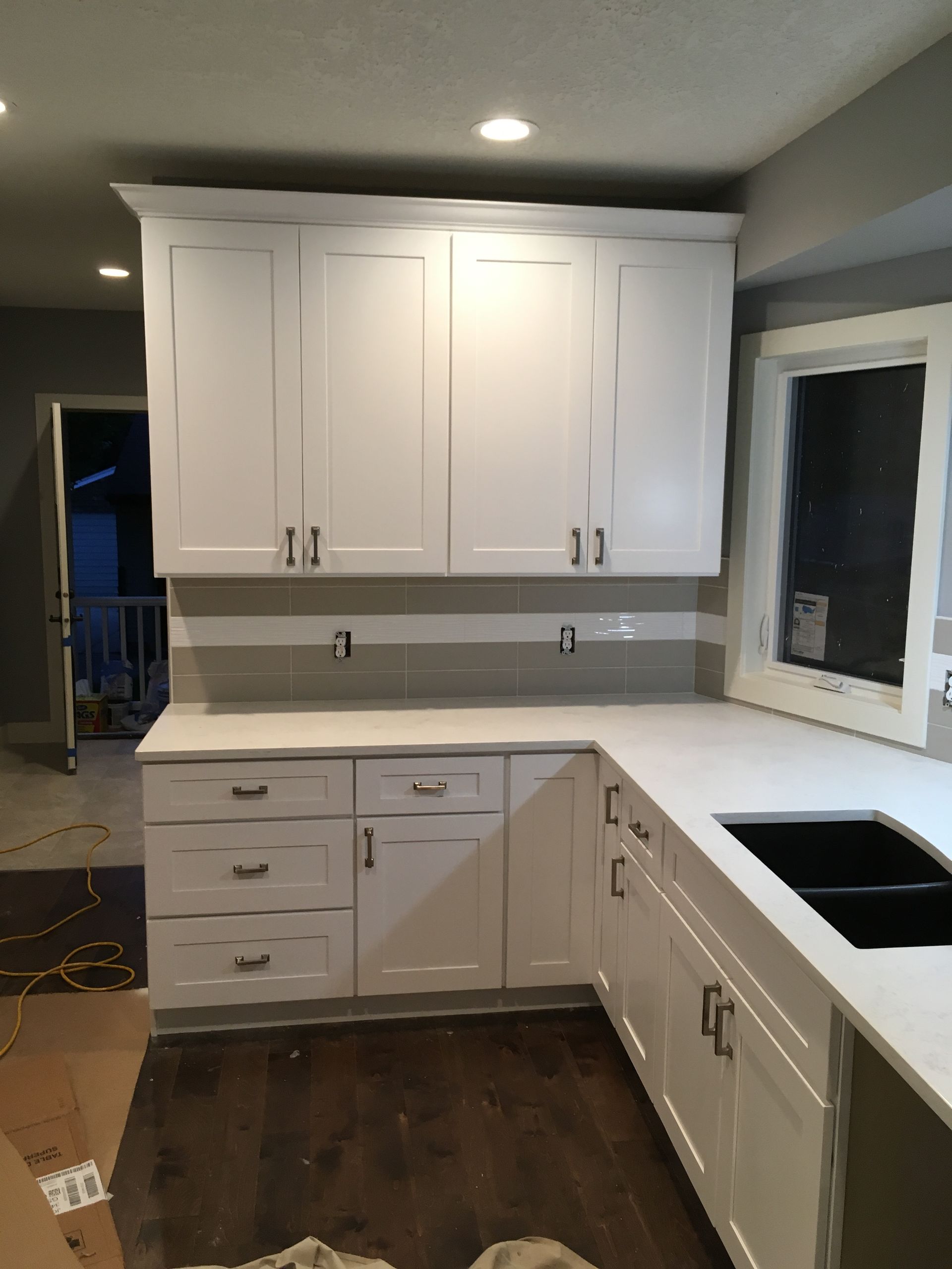 a kitchen with white cabinets and white counter tops