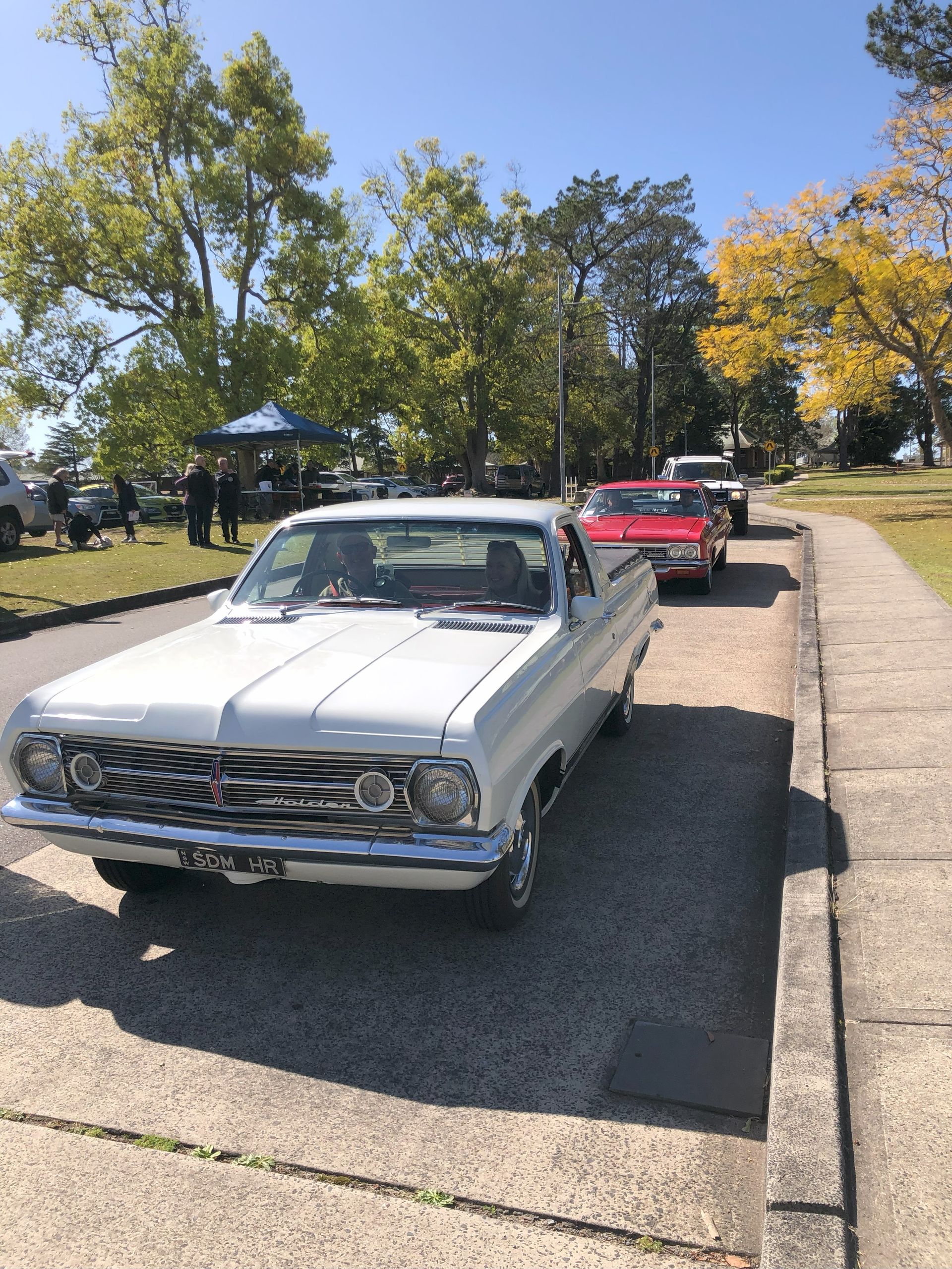 A white car is parked on the side of the road