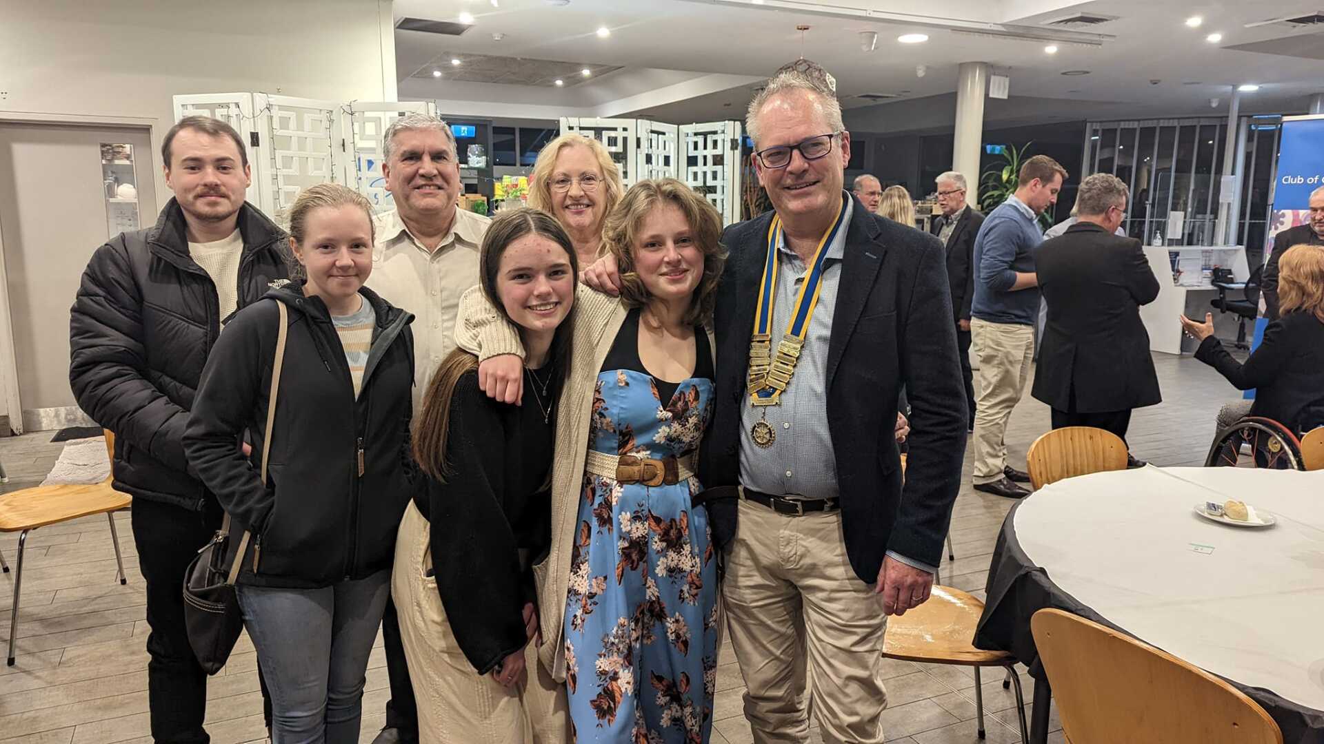 A group of people are posing for a picture in a room.