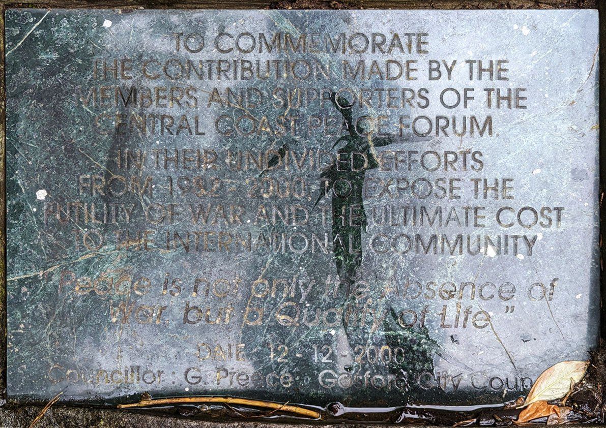 A plaque that says to commemorate the contribution made by the members and officers of the central committee of the forum