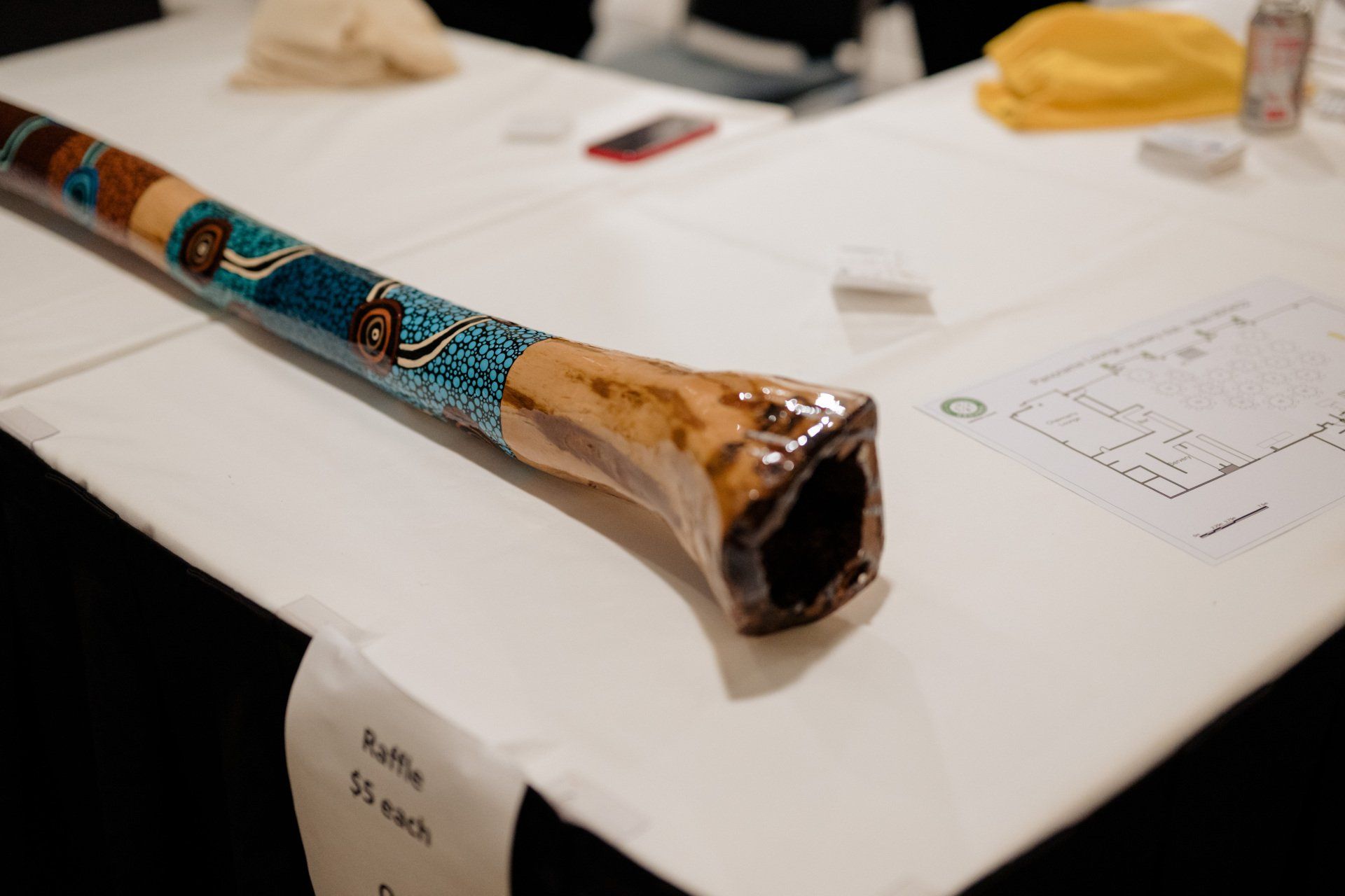A colorful didgeridoo is sitting on a table.