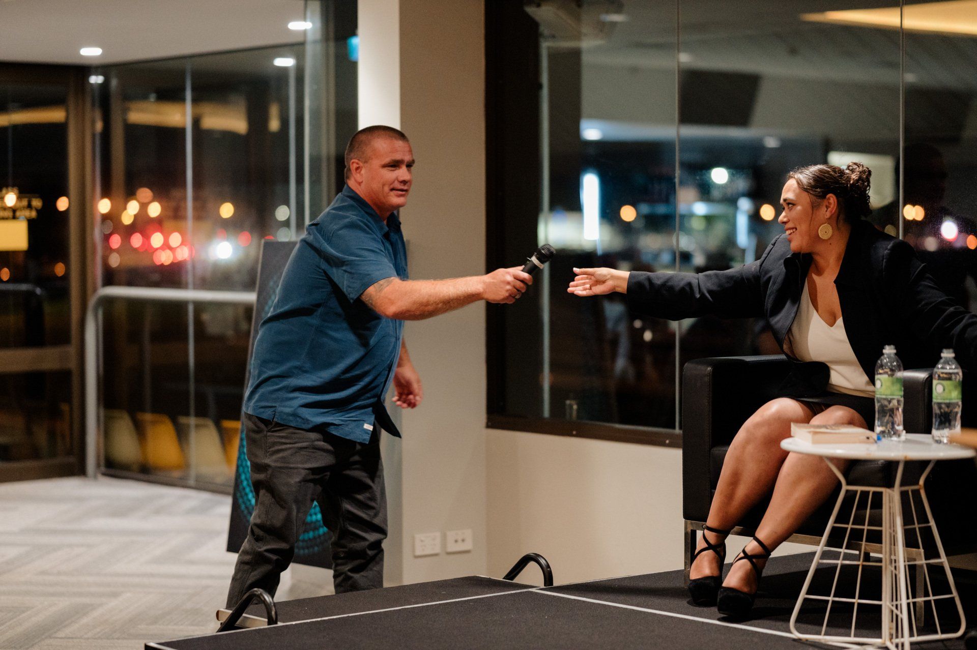 A man and a woman are playing ping pong in a room.