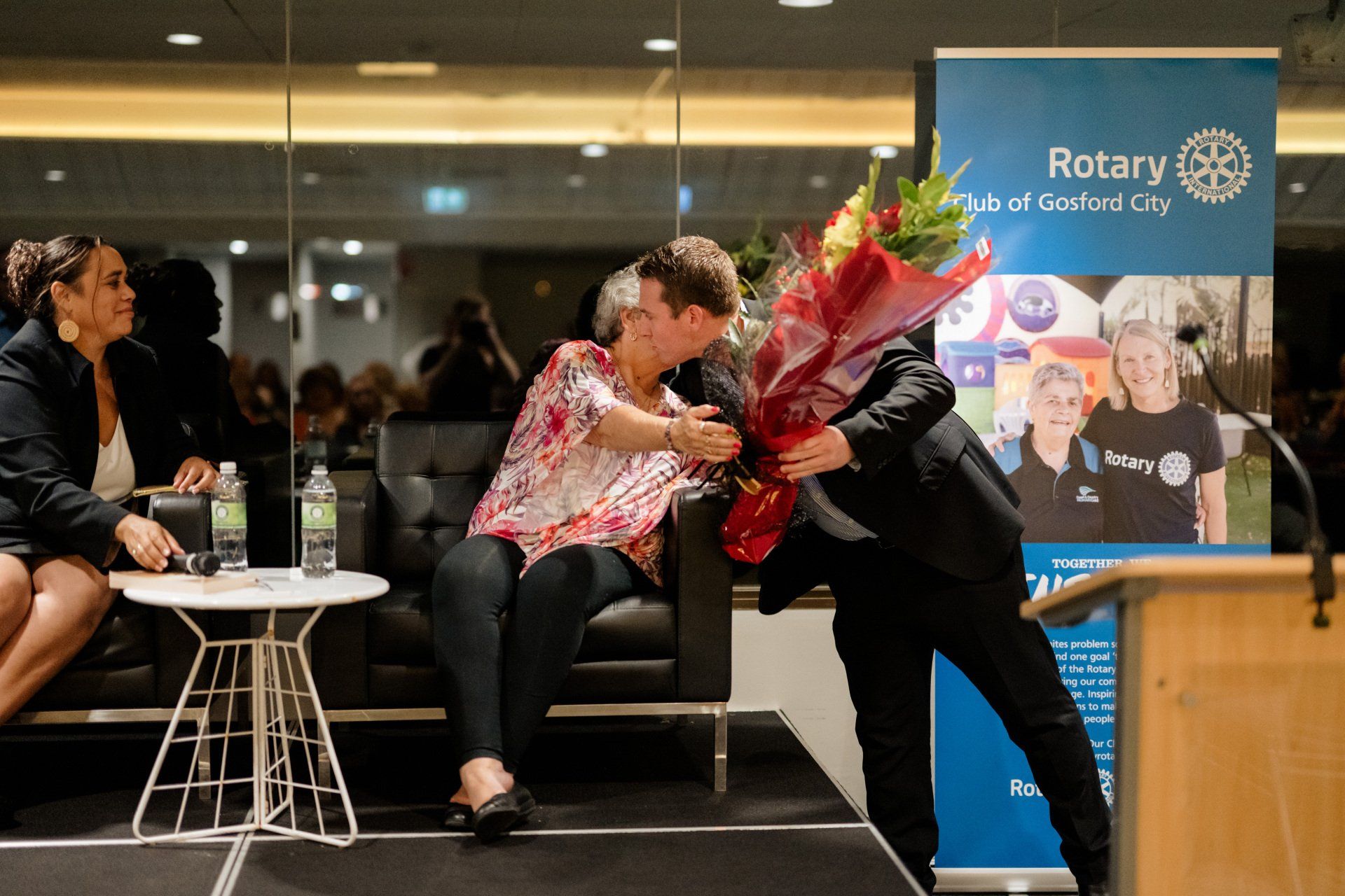 A man is giving a woman a bouquet of flowers.