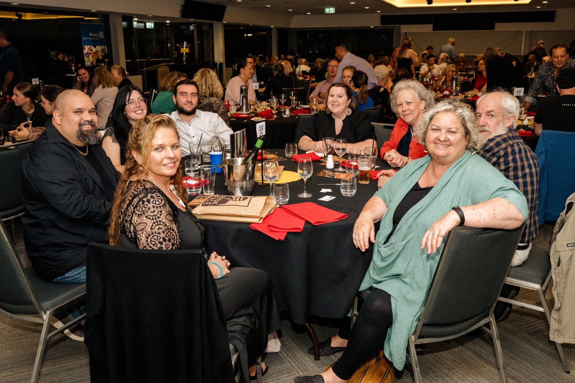 A group of people are sitting at tables in a room.