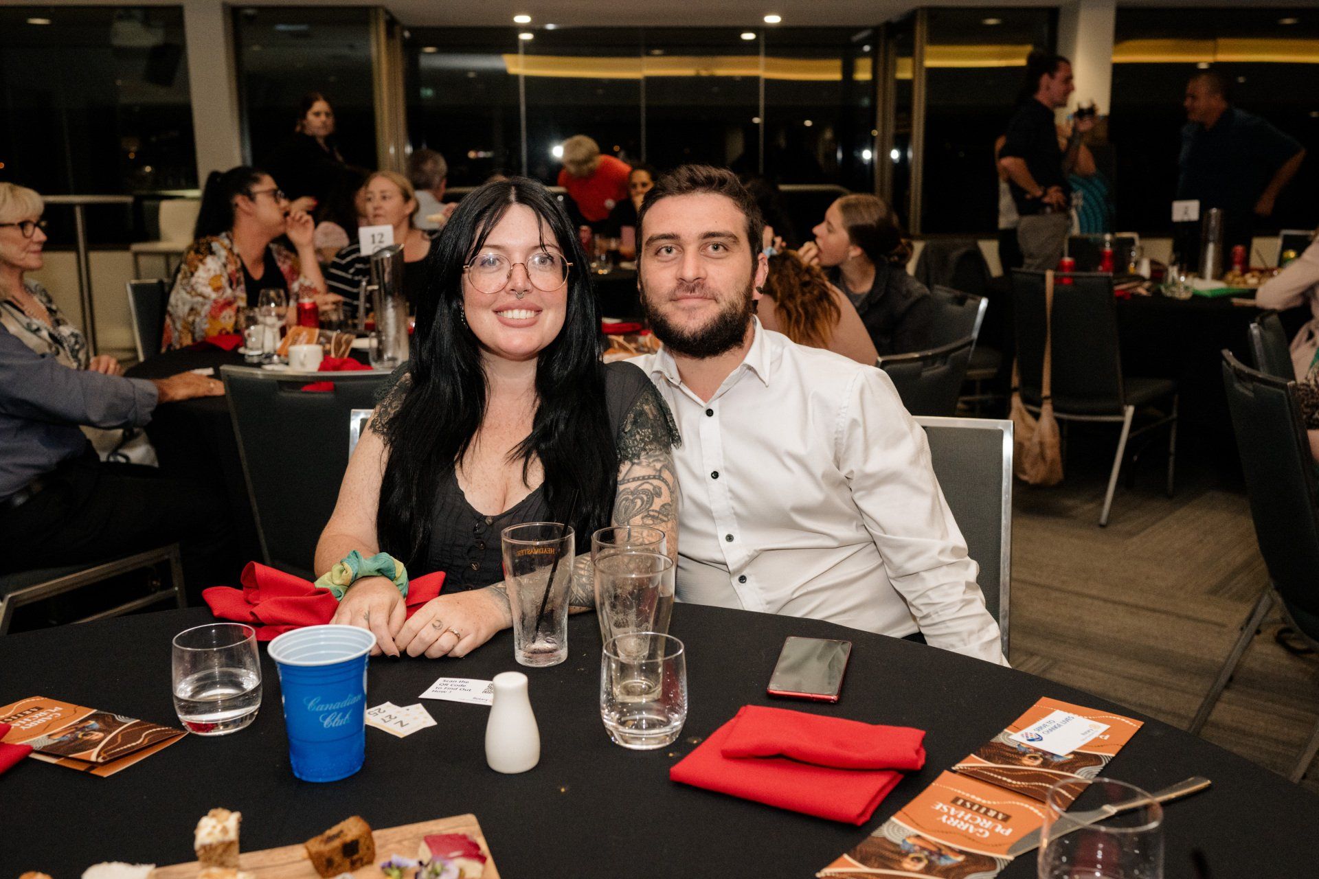 A man and a woman are sitting at a table in a restaurant.