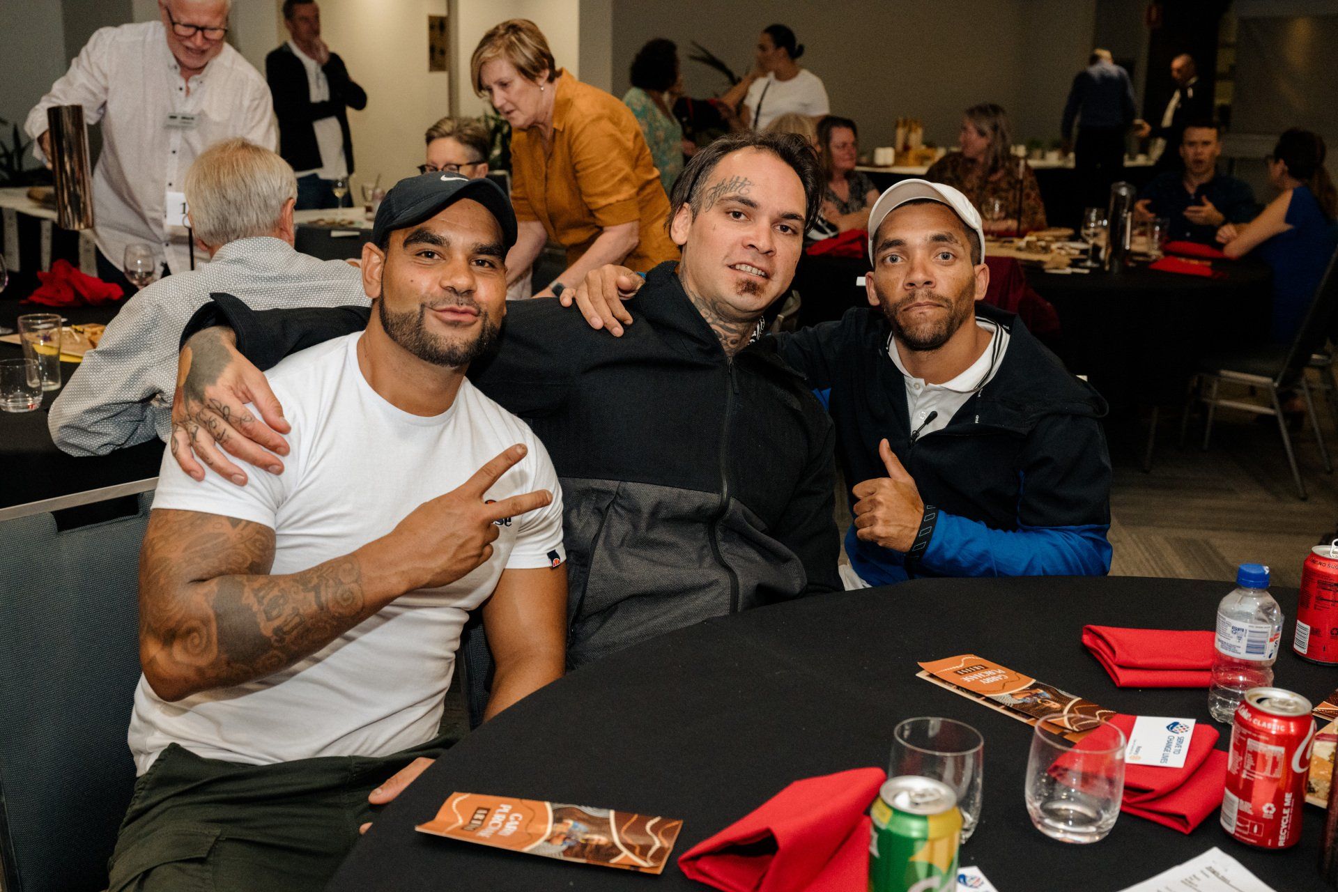 A group of men are posing for a picture at a table.
