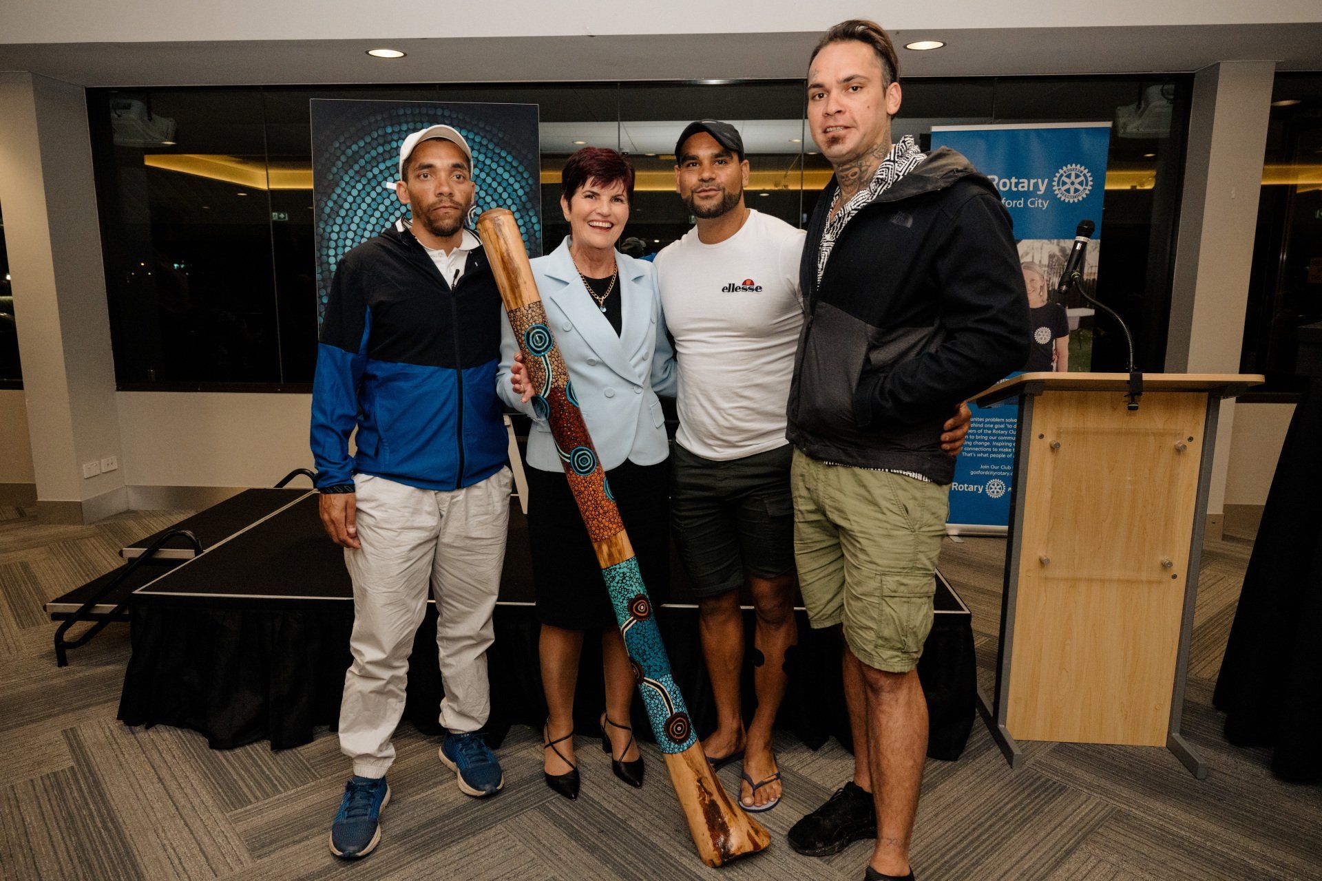 A group of people are posing for a picture in front of a podium.
