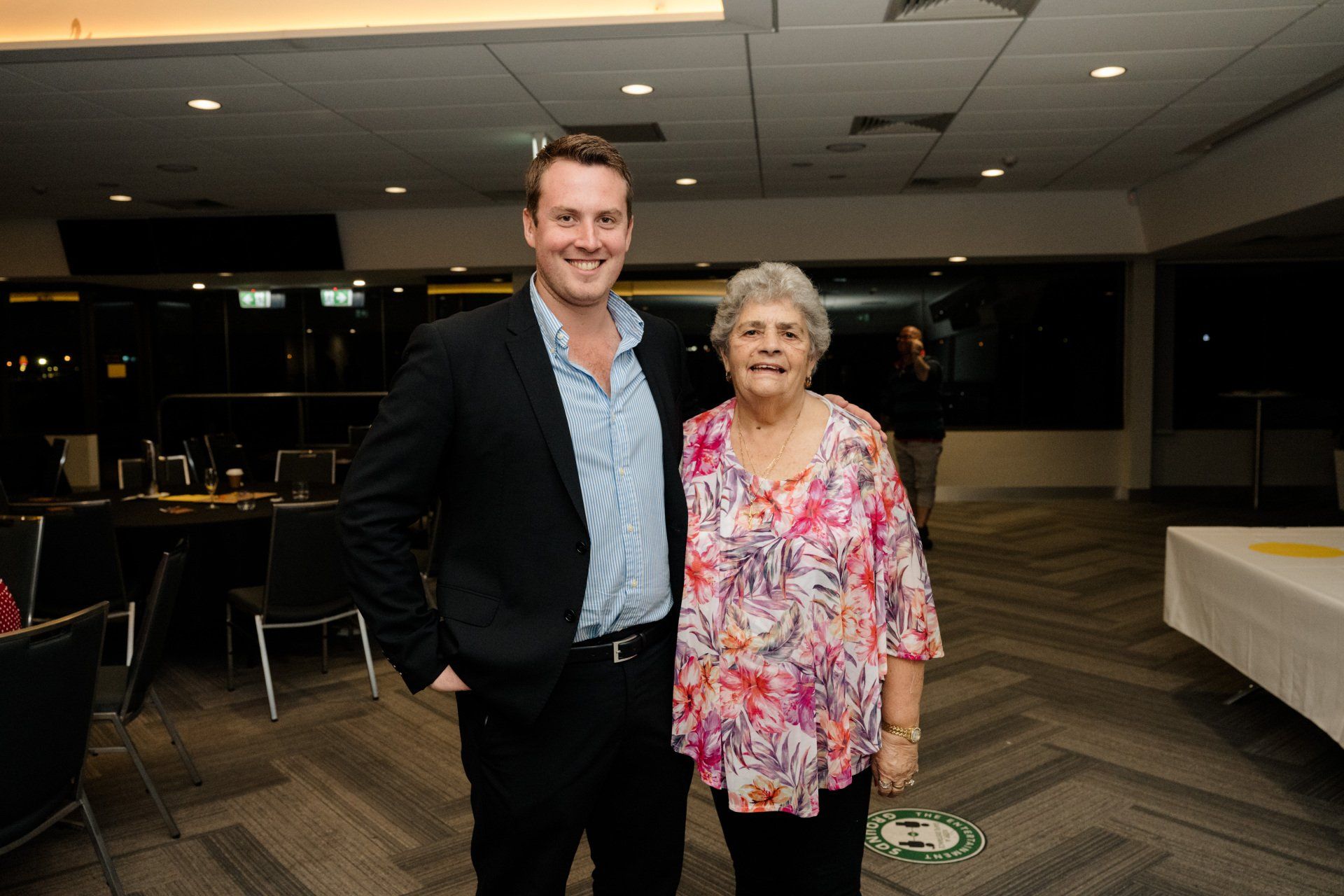 A man and a woman are standing next to each other in a room.
