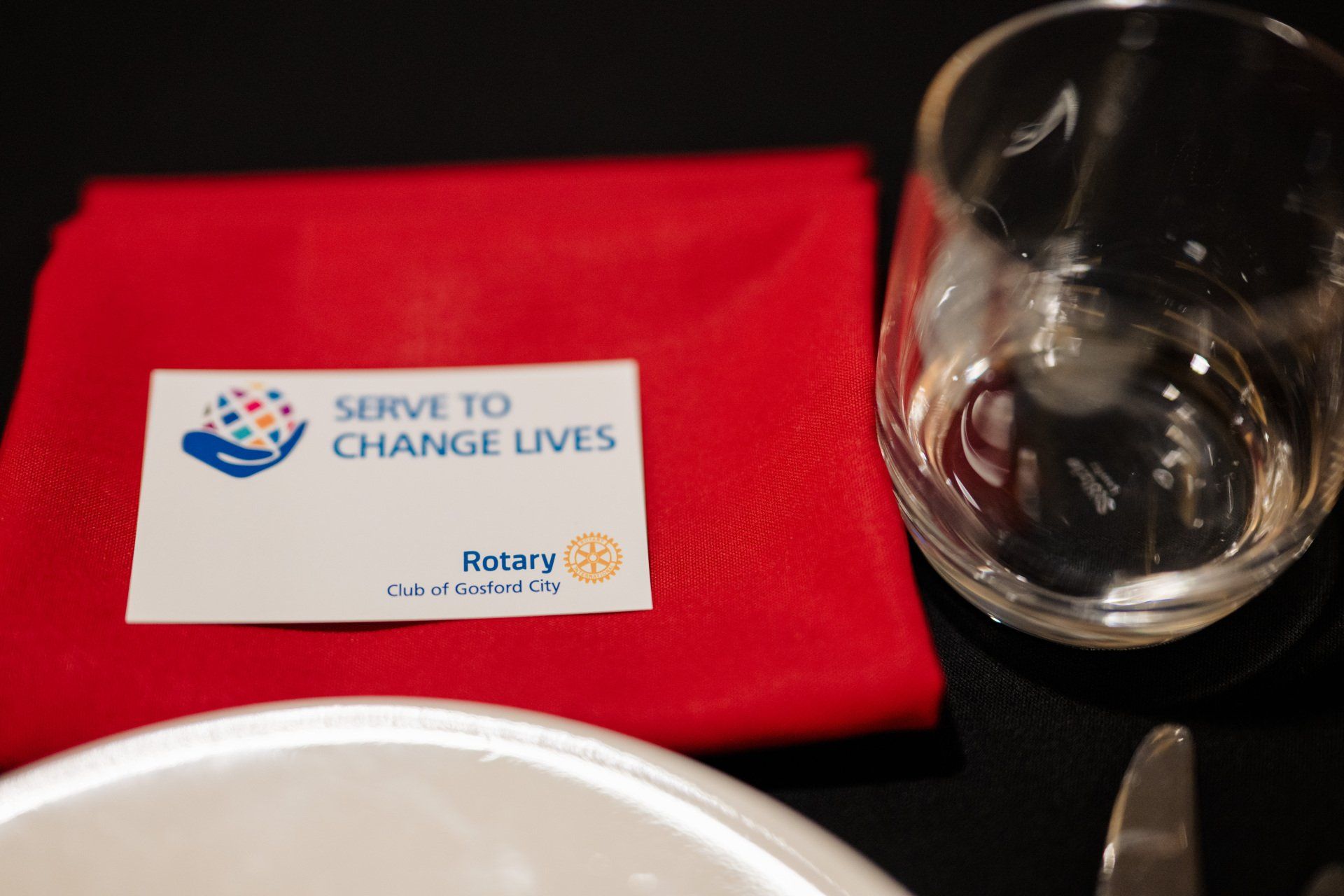 A red napkin with a sign that says serve to change lives