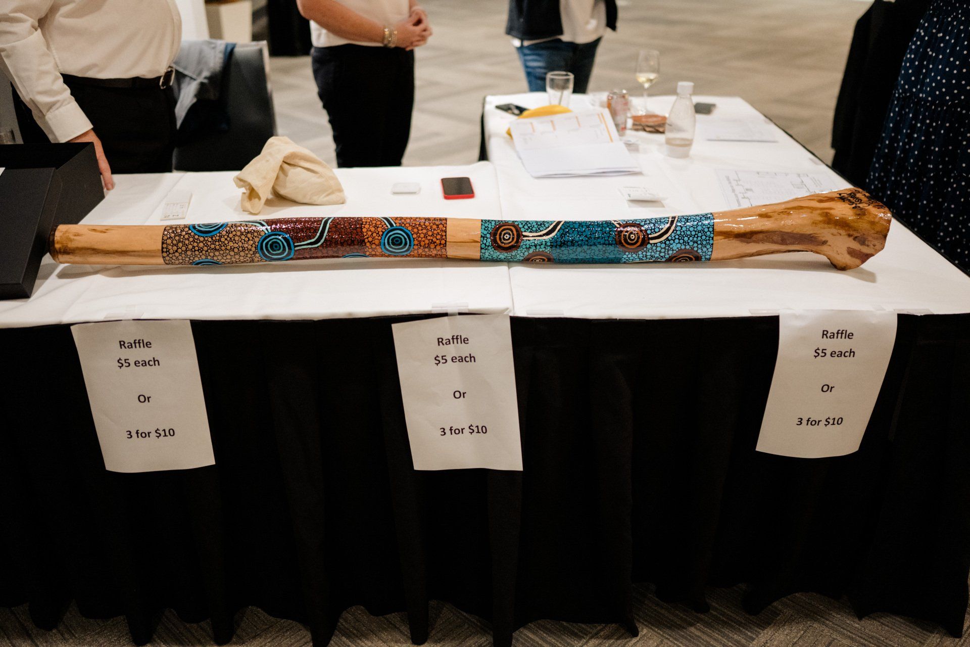 A large wooden stick is sitting on top of a table.