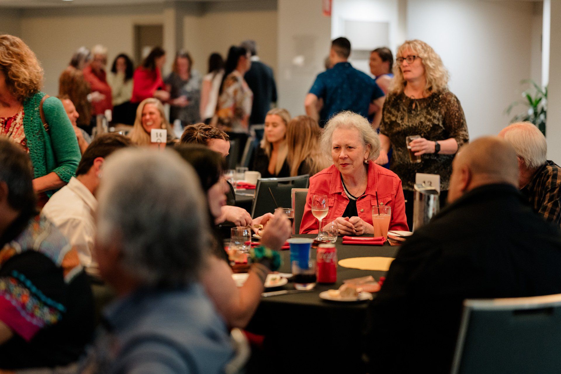 A group of people are sitting at tables in a room.