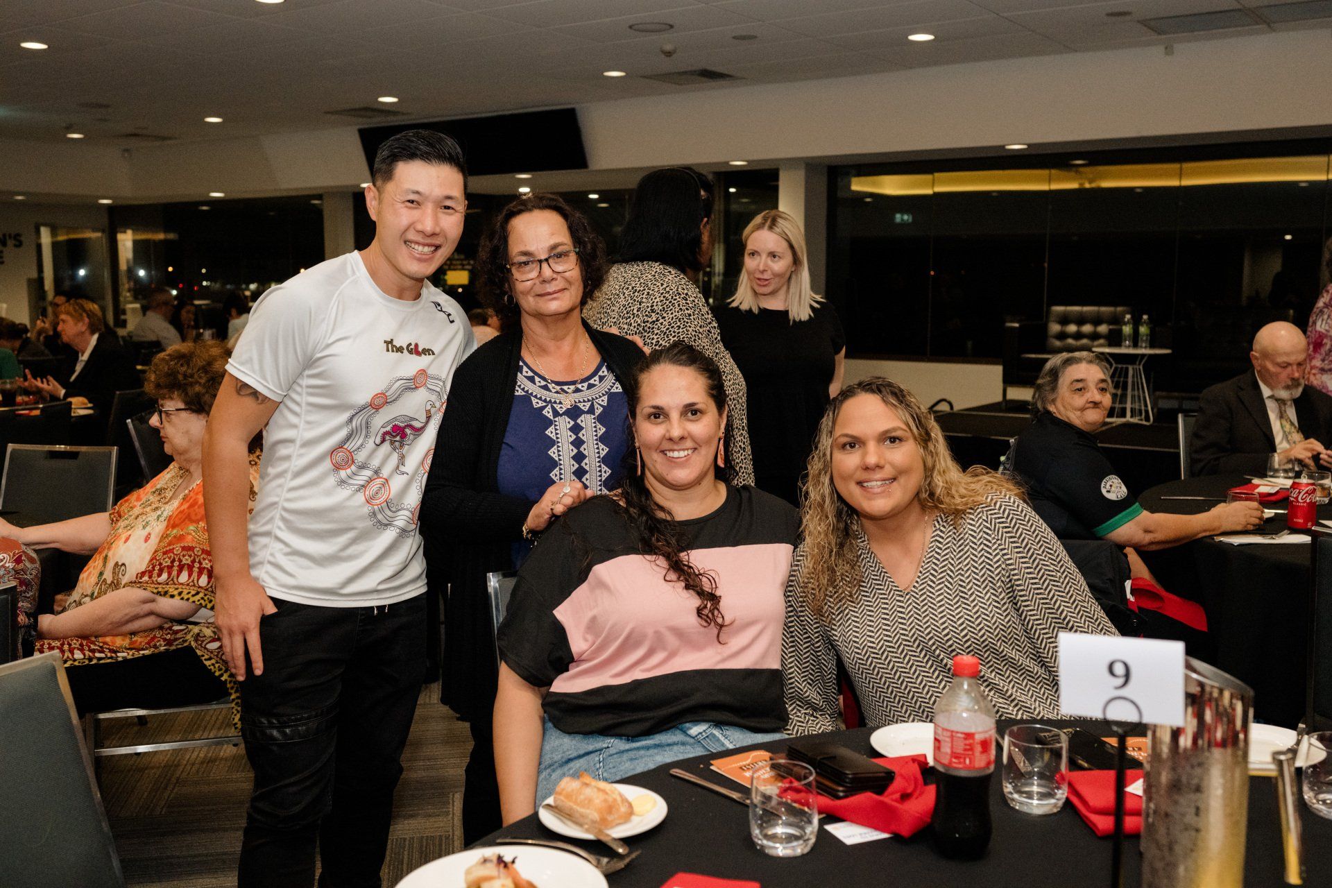 A group of people are posing for a picture at a restaurant.