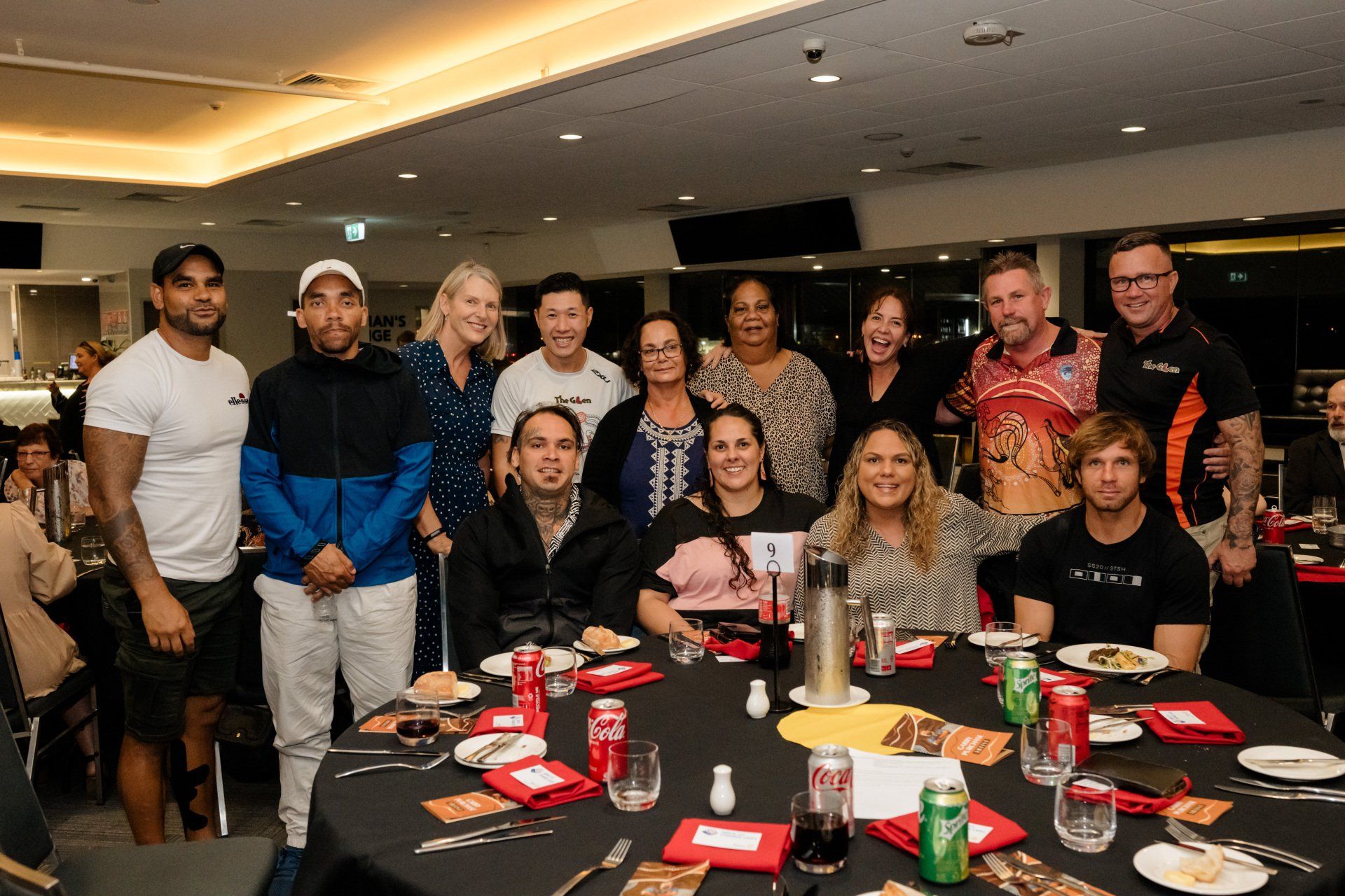 A group of people are posing for a picture at a table.