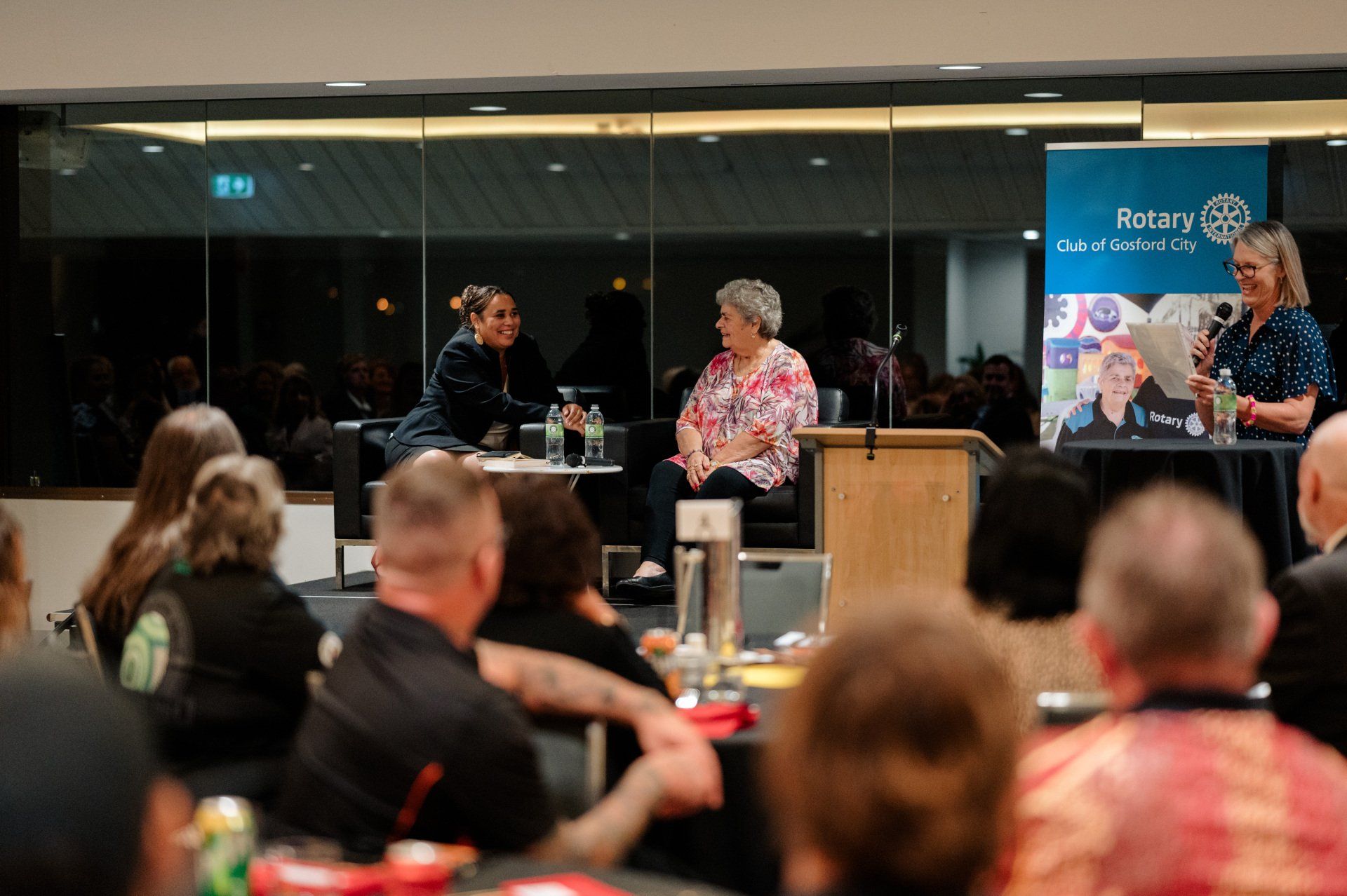 A group of people are sitting at tables in a room.