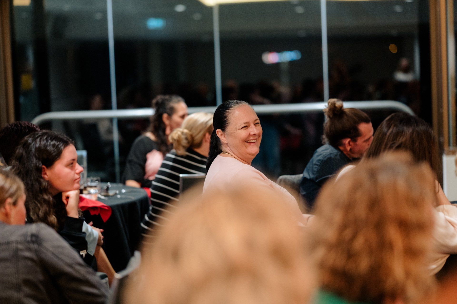 A group of people are sitting at tables in a room.
