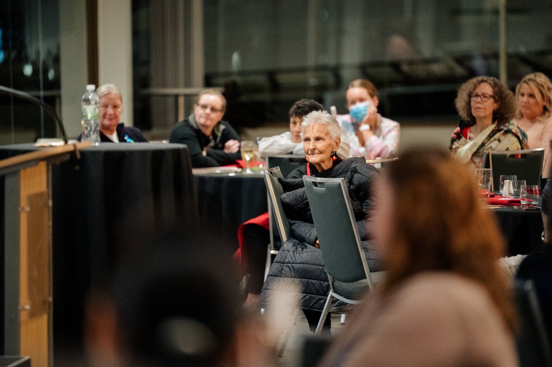 A group of people are sitting at tables in a room.