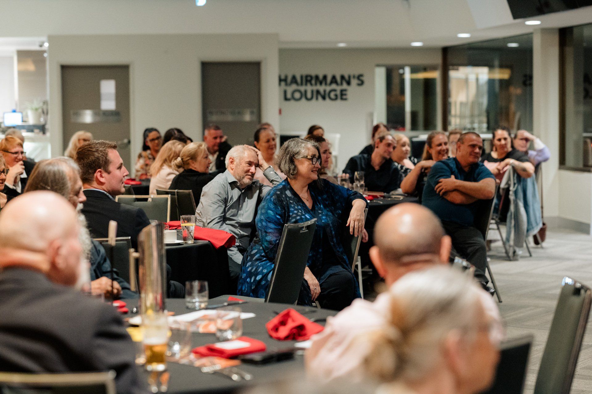A group of people are sitting at tables in a room.