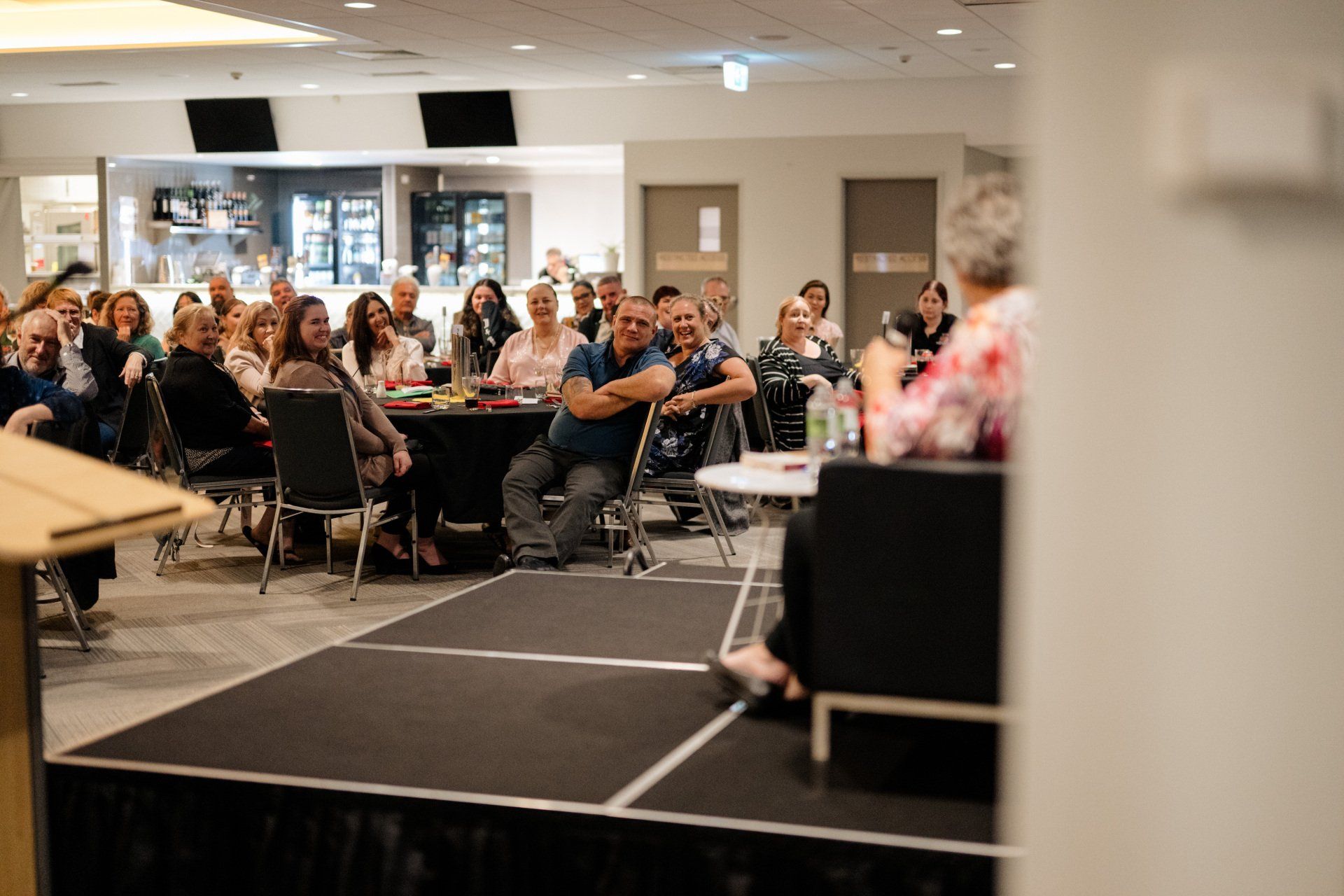 A group of people are sitting at tables in a room.