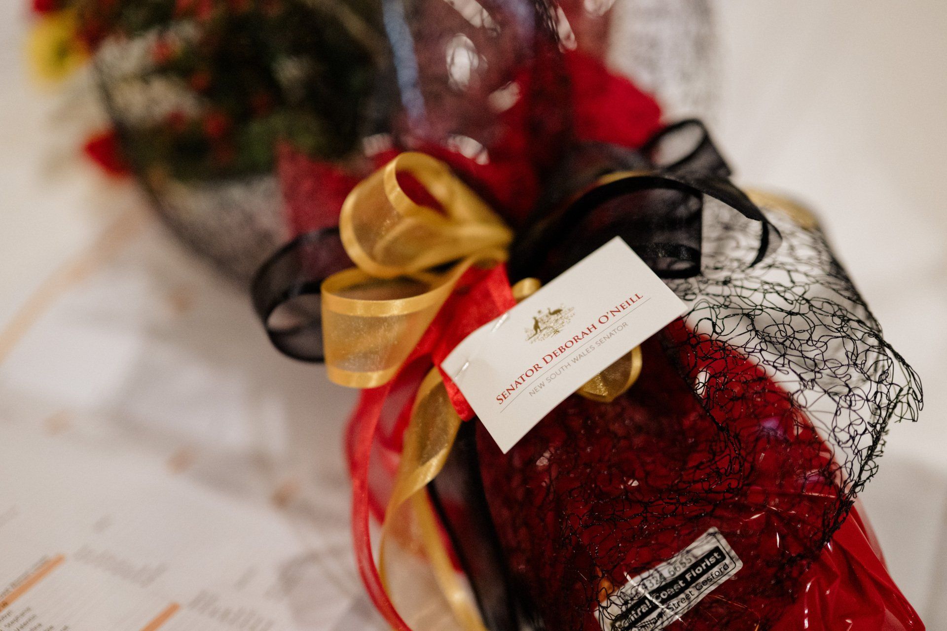 A close up of a red socks with a tag on it on a table.