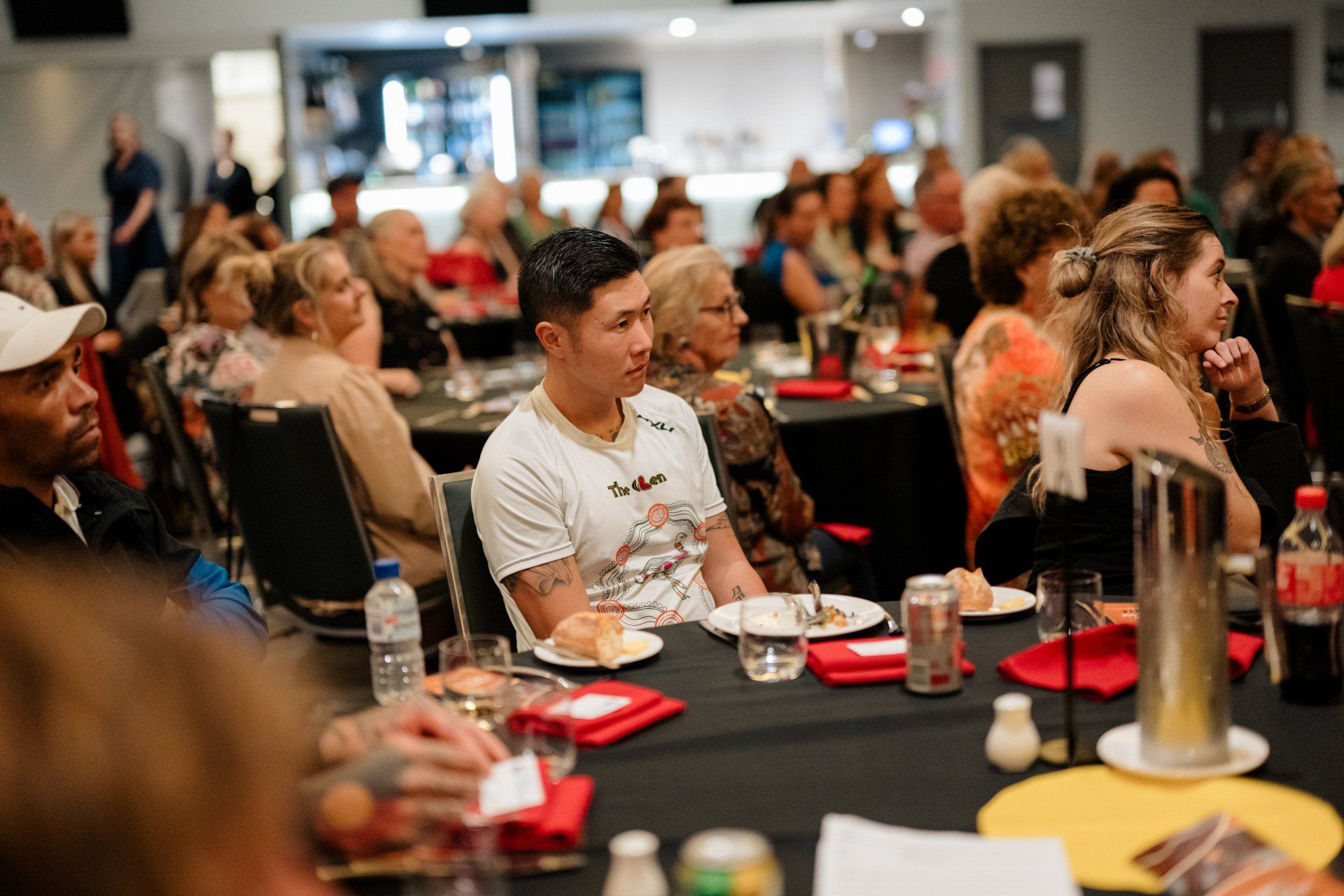 A group of people are sitting at tables in a room.