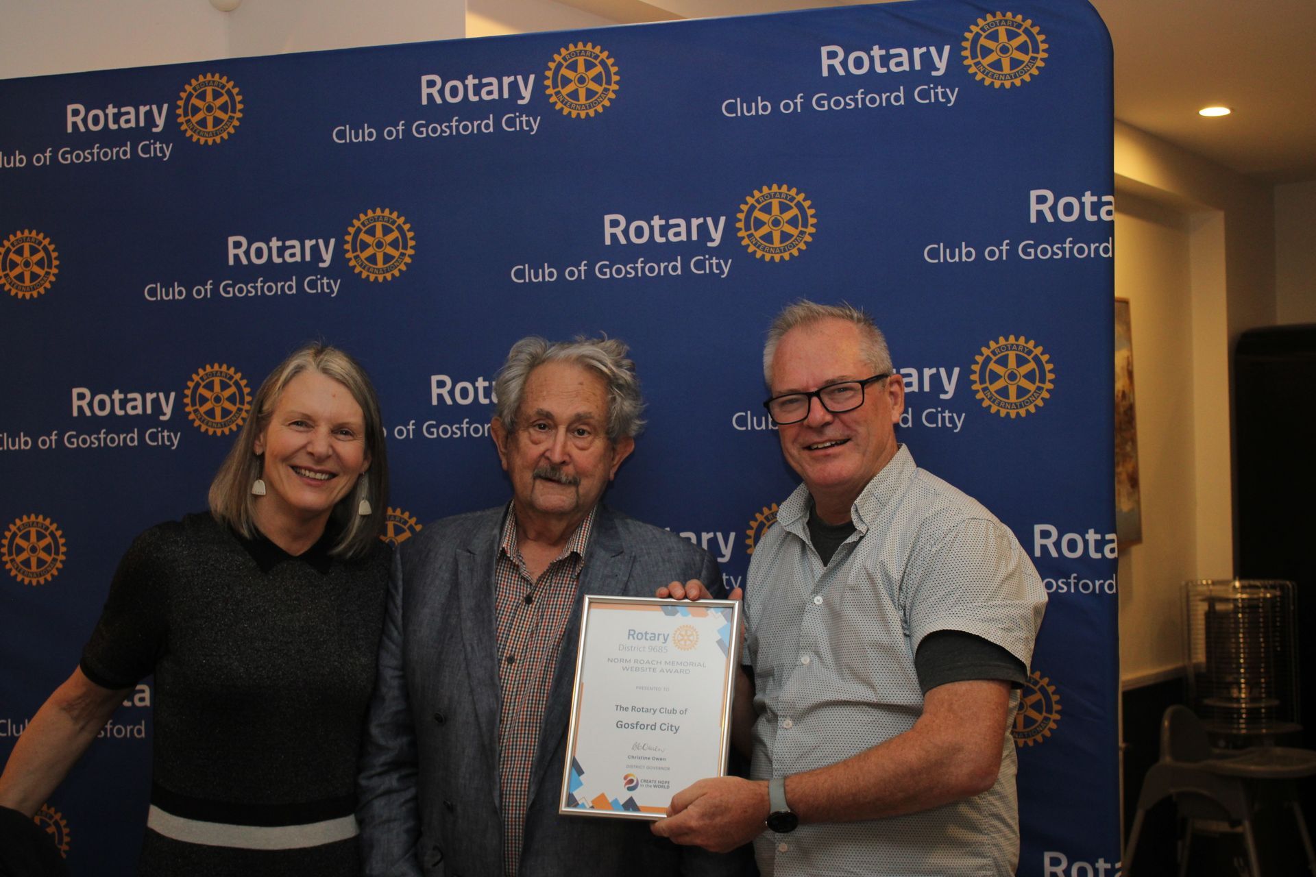 A group of people standing next to each other holding a certificate.