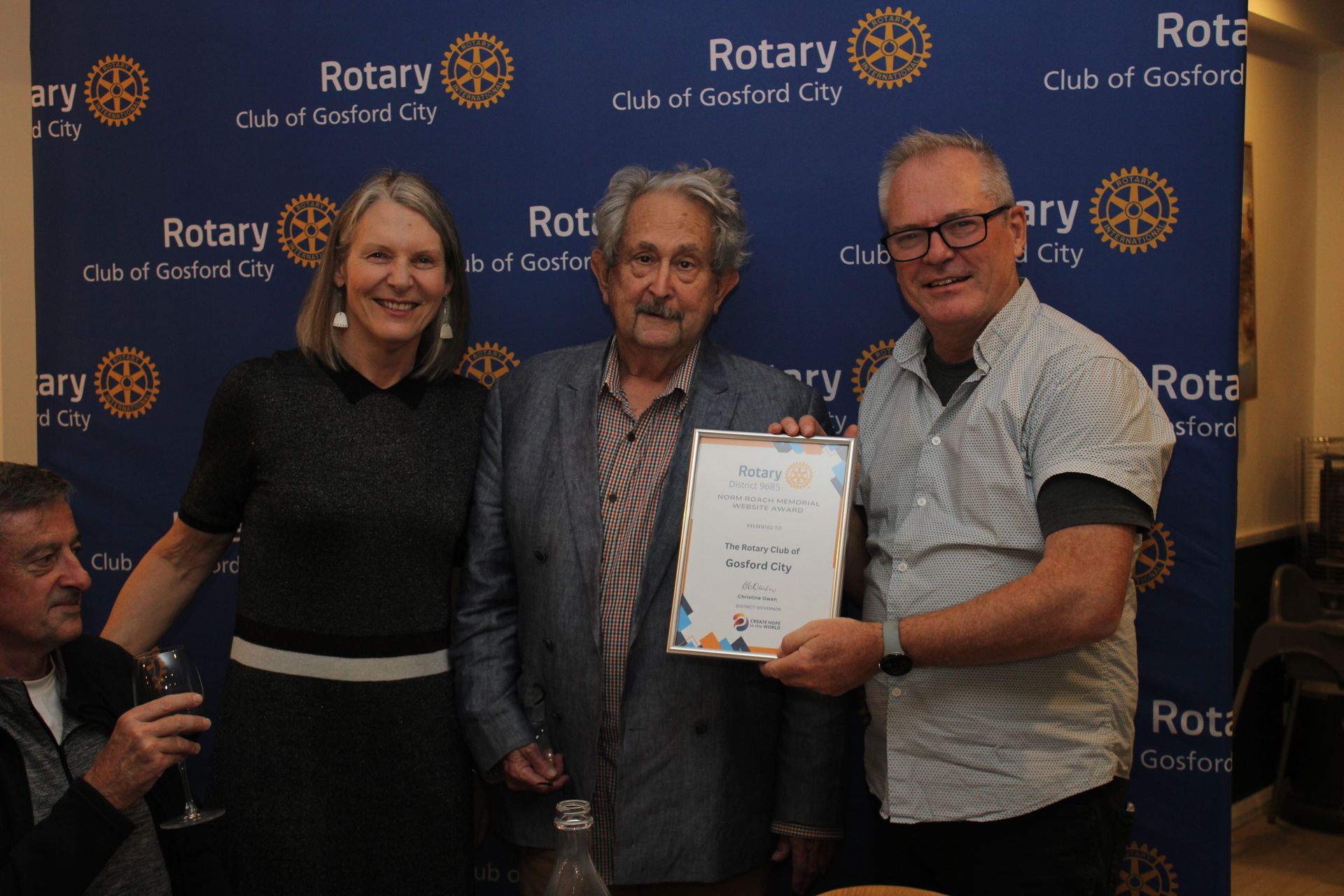 A group of people standing next to each other holding a certificate.