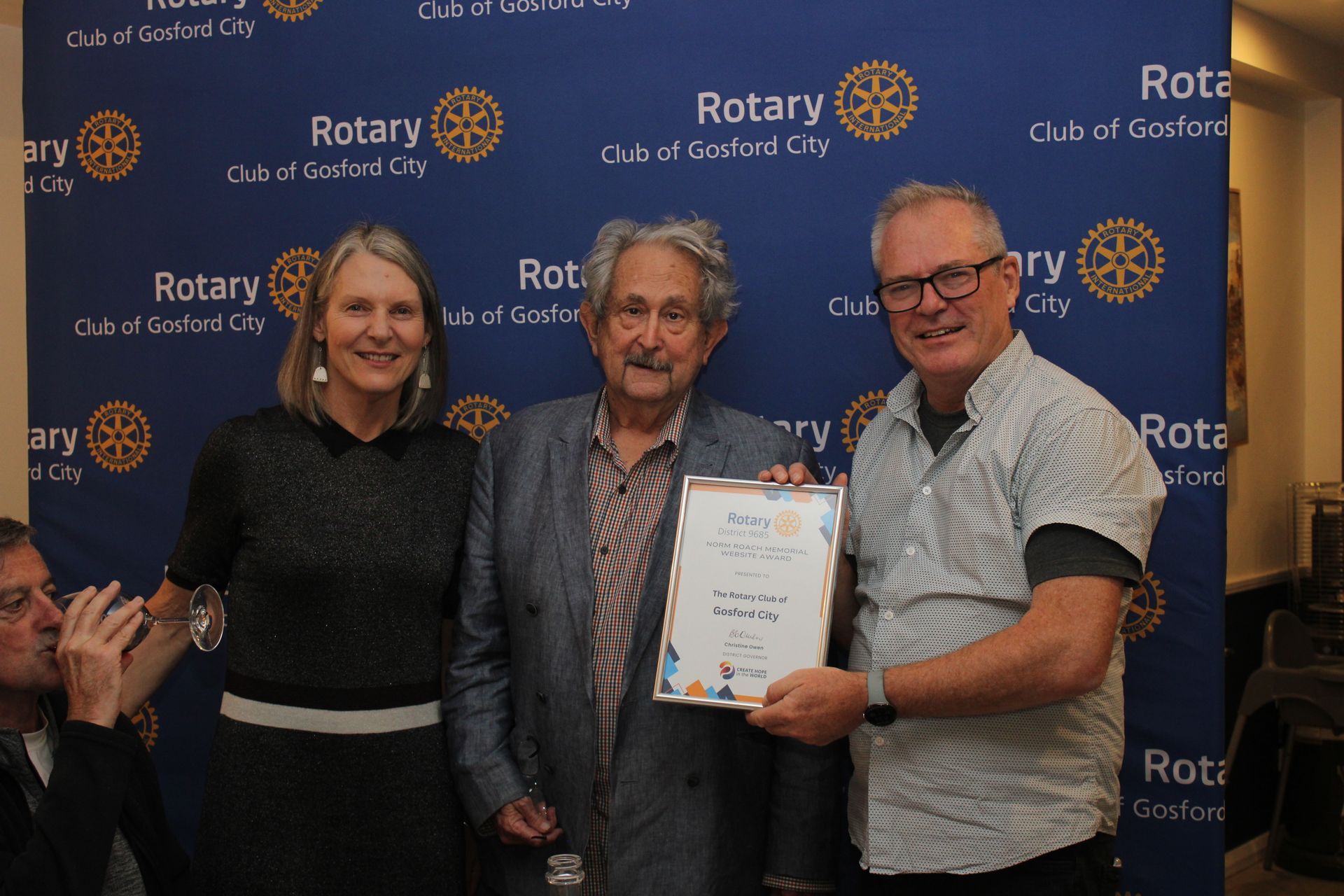 A group of people standing next to each other holding a certificate.