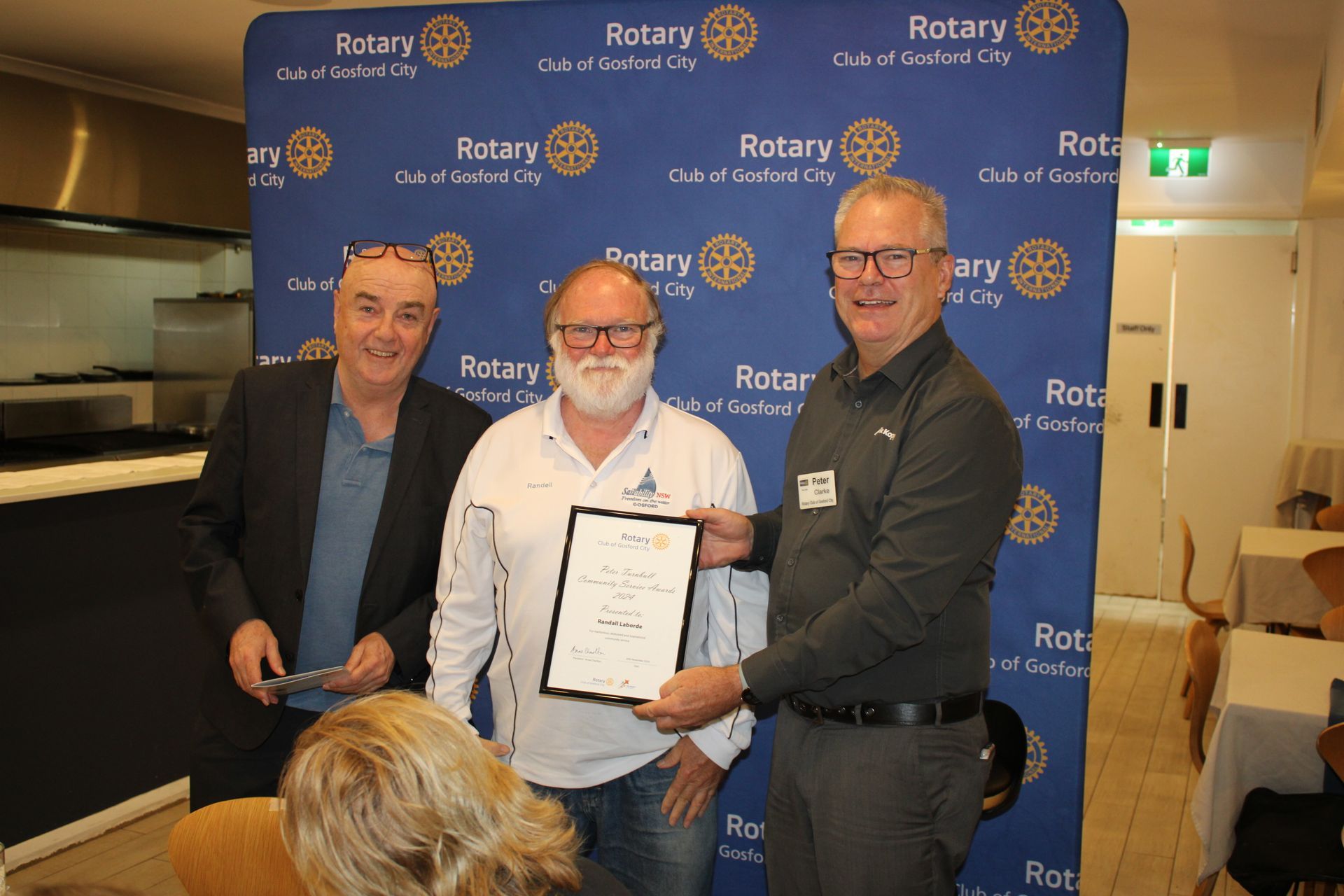 A group of men are standing next to each other holding a certificate.