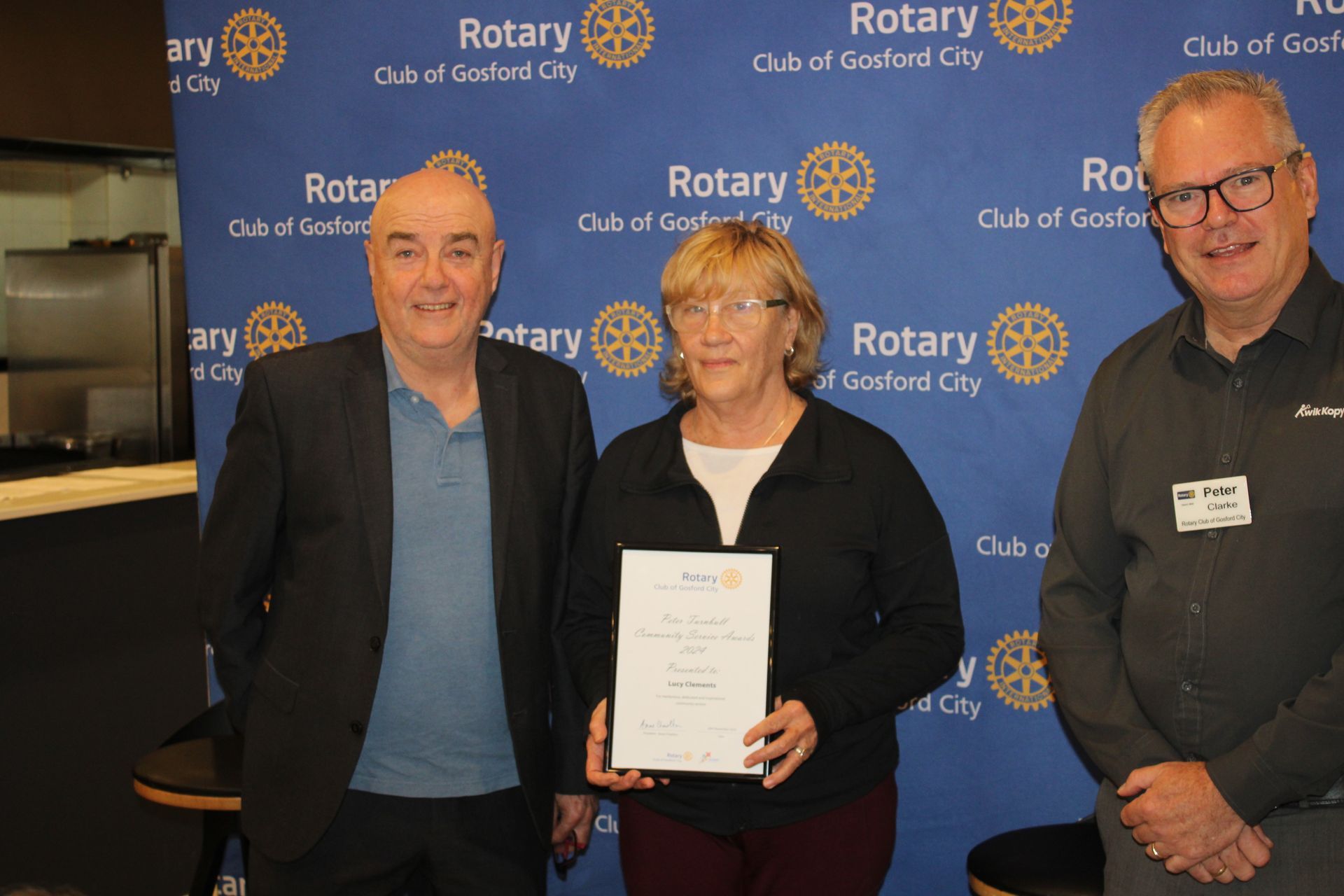 A group of people standing next to each other holding a certificate.