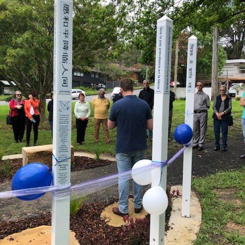 A man stands in front of a sign that says