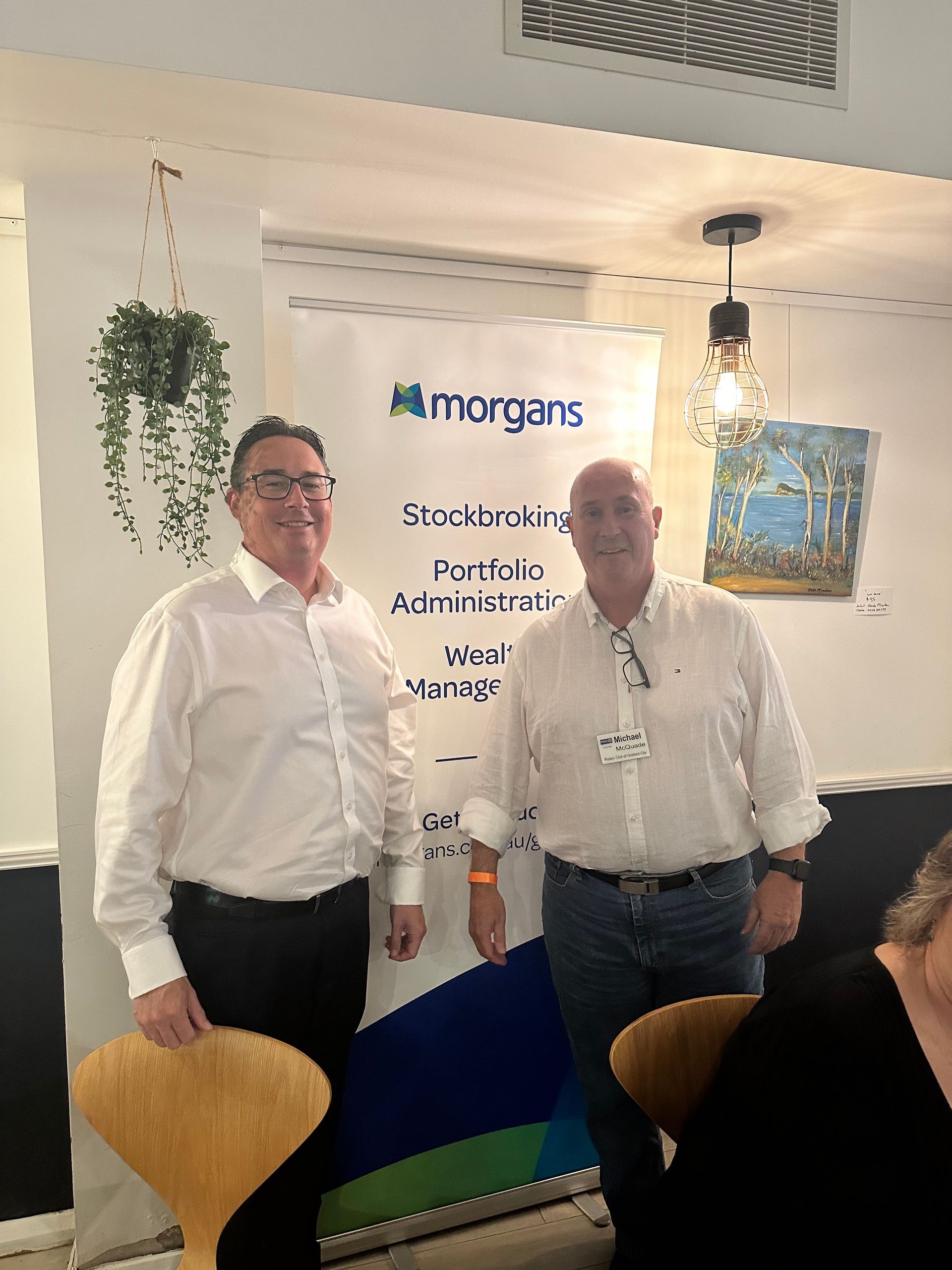 Two men are standing next to each other in a room.