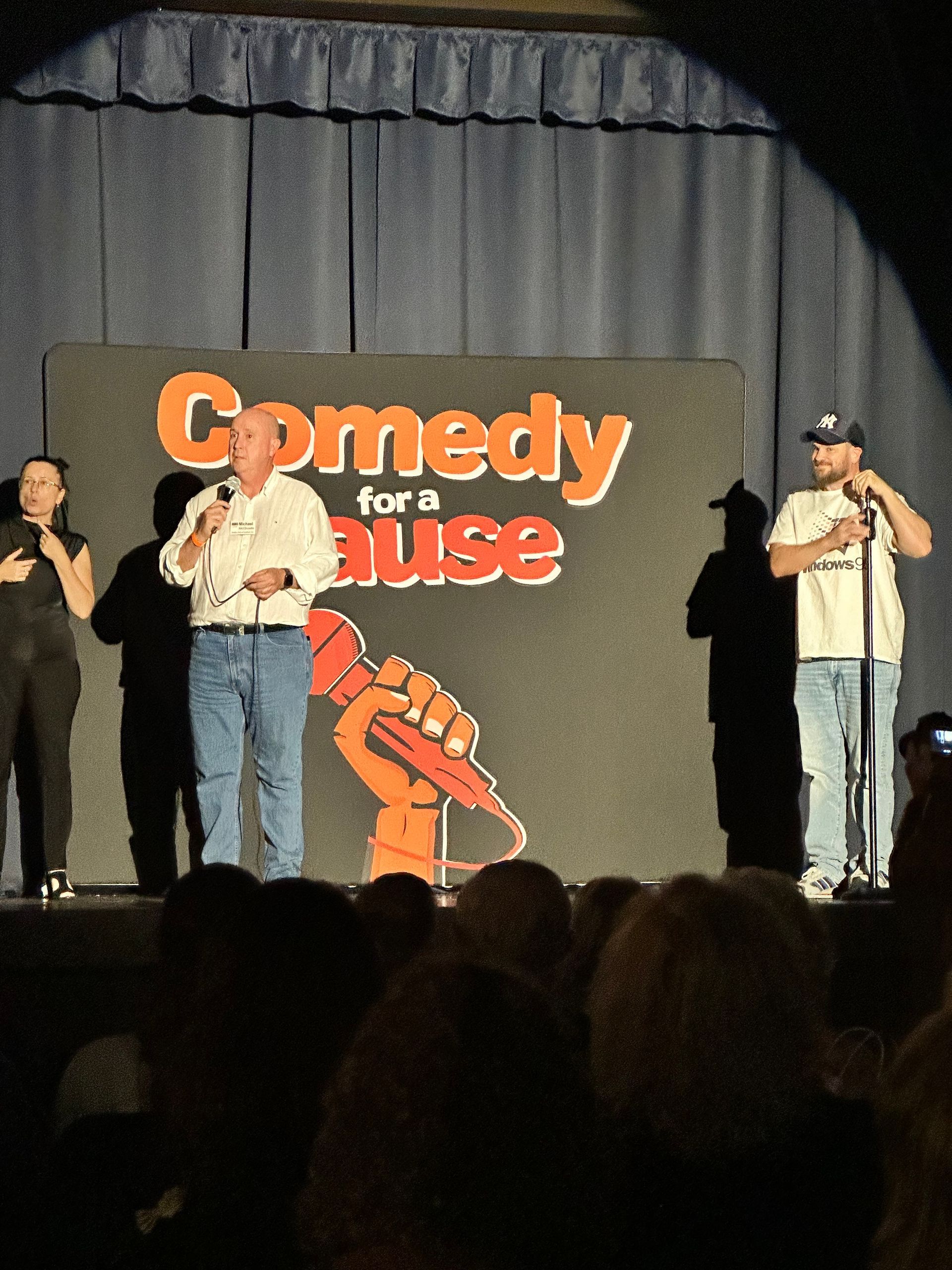 A comedy for a cause event is taking place on a stage