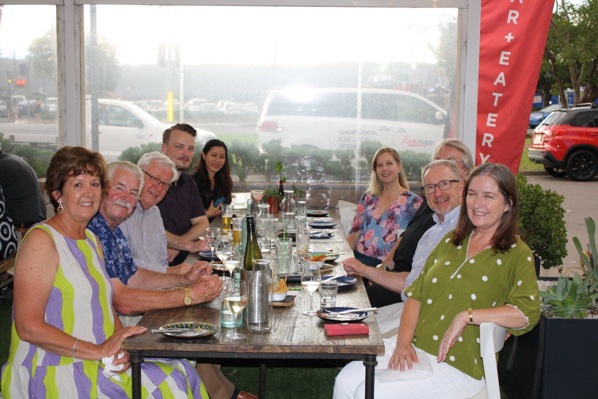 A group of people are sitting at a long table.