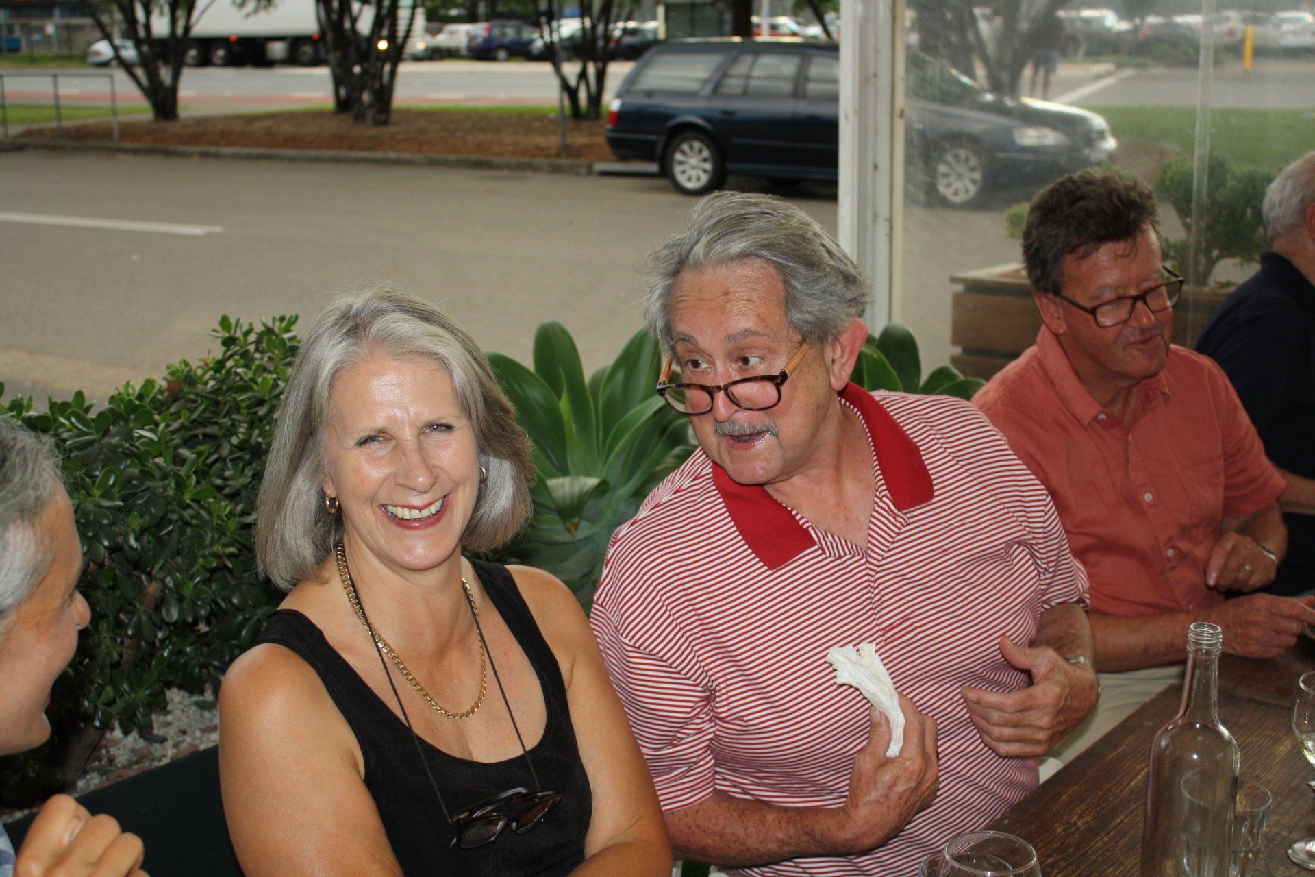 A group of people are sitting at a table and smiling