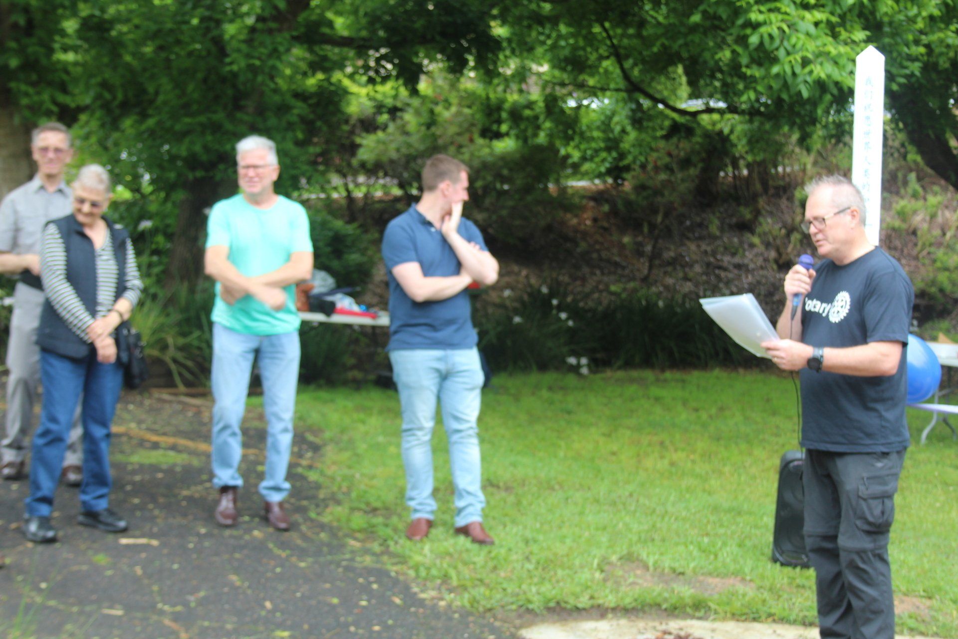 A man is giving a speech in front of a group of people
