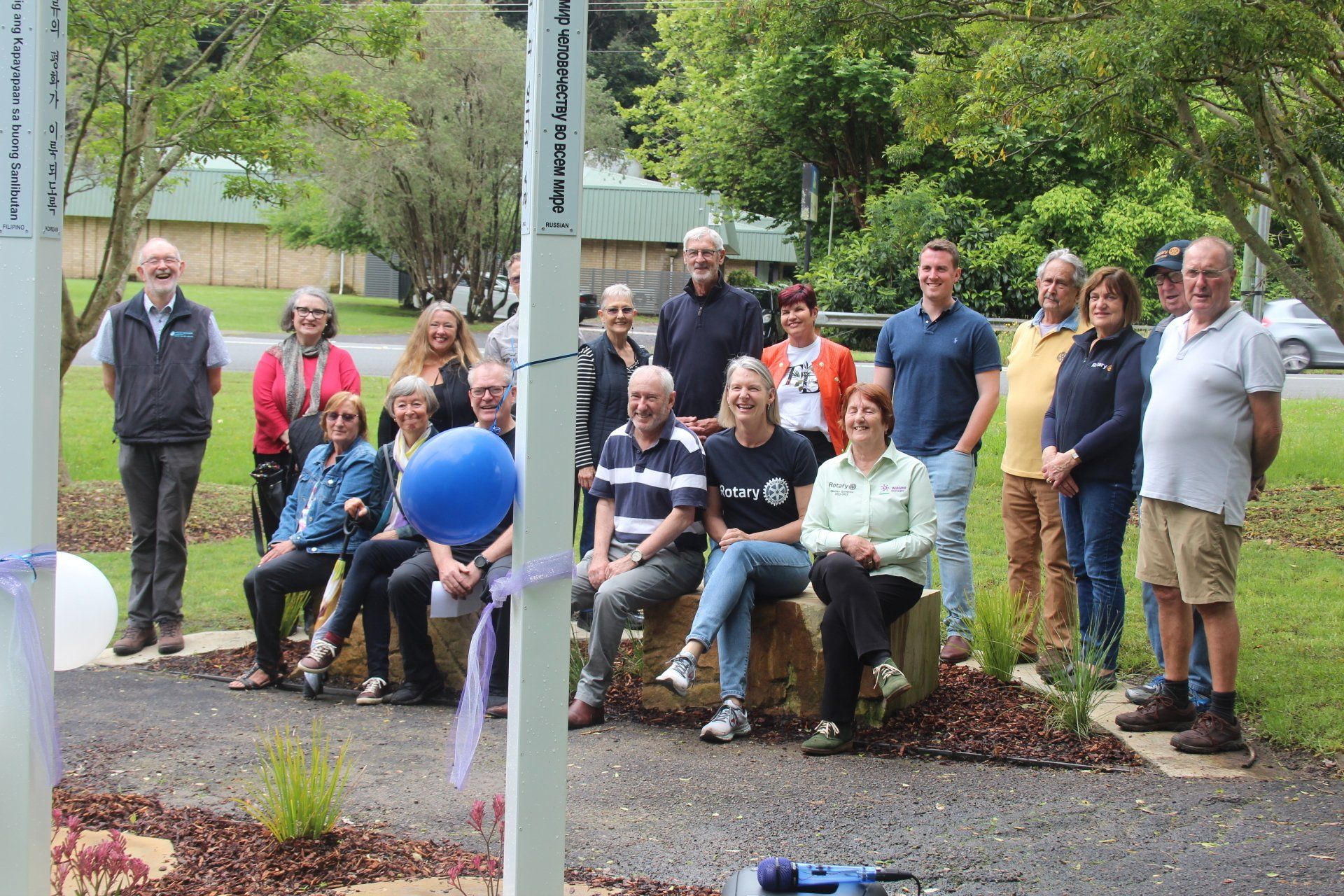A group of people are posing for a picture in a park.