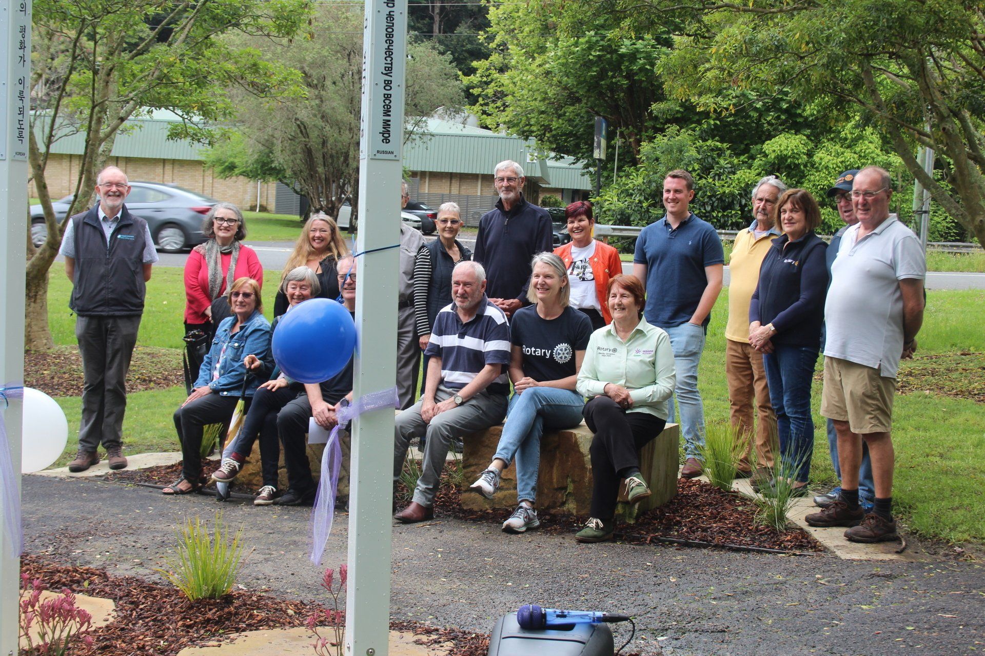 A group of people are posing for a picture in a park.