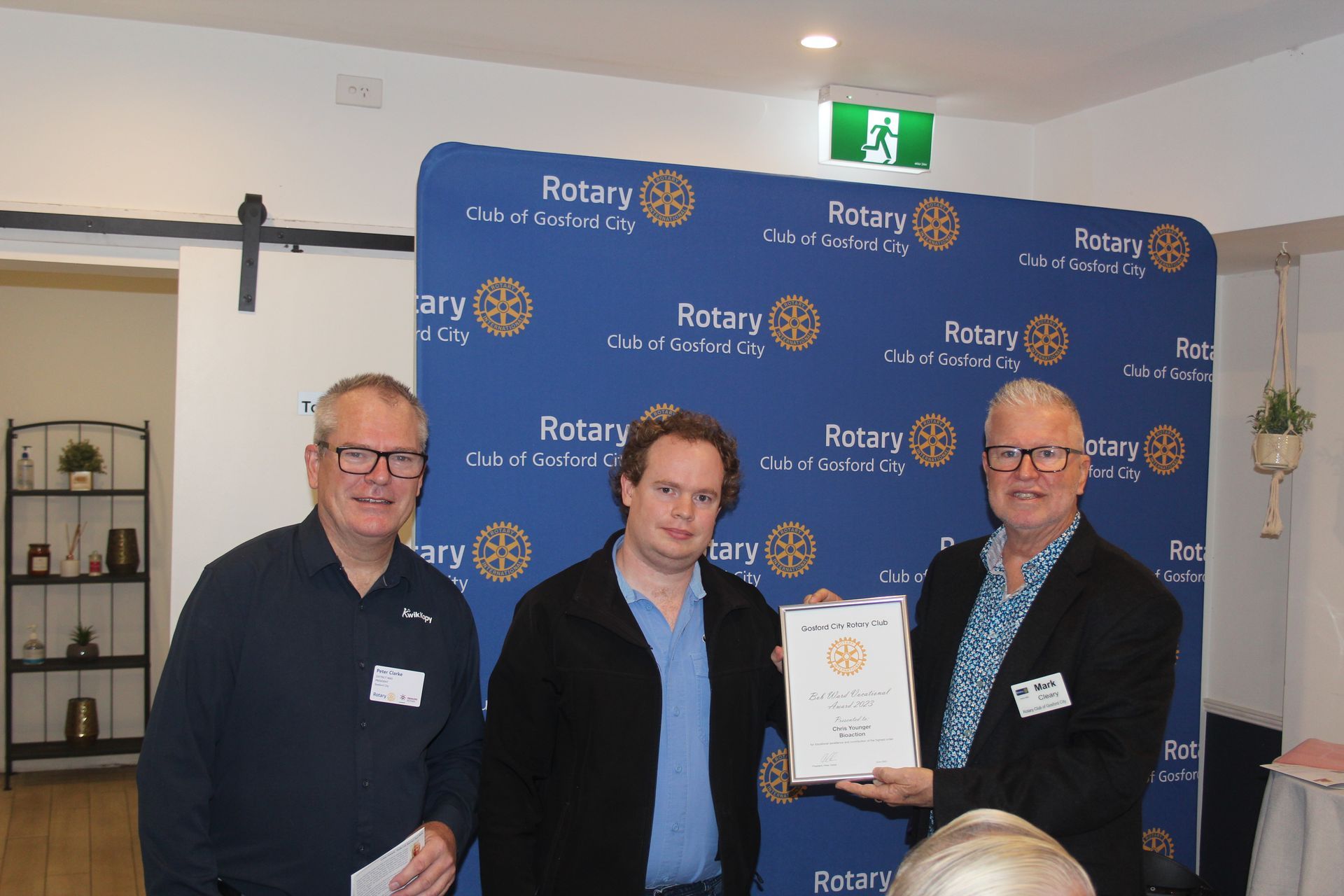 A group of men are standing next to each other holding a certificate.