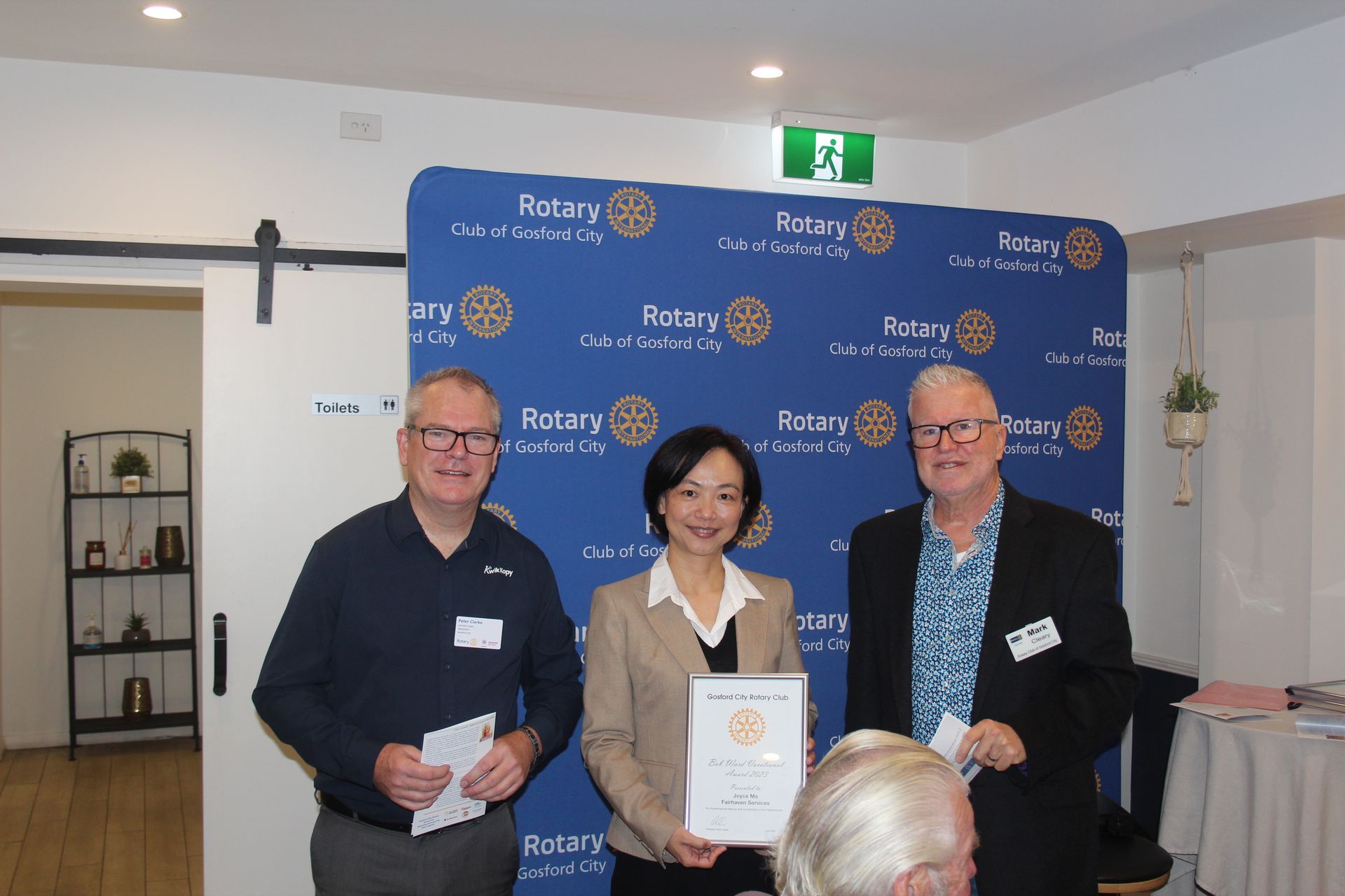 A group of people standing next to each other holding a certificate.