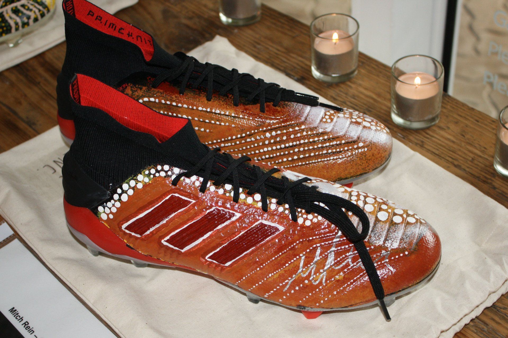 A pair of brown and black soccer cleats on a table