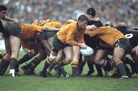A group of men are playing rugby on a field.