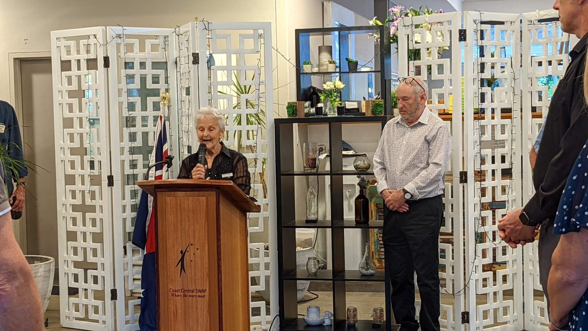 A man is standing at a podium giving a speech to a group of people.