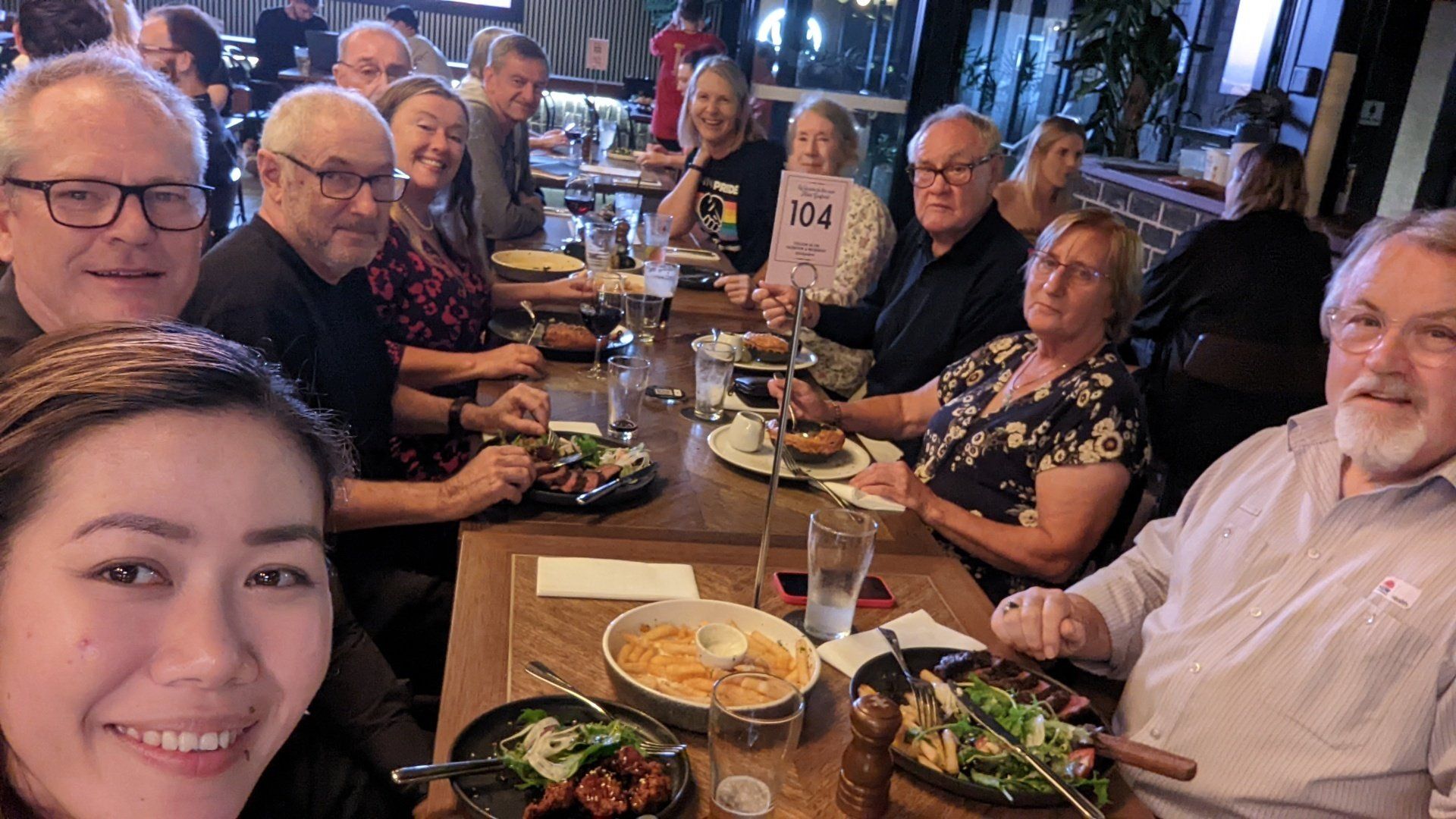 A group of people are sitting at a table eating food.
